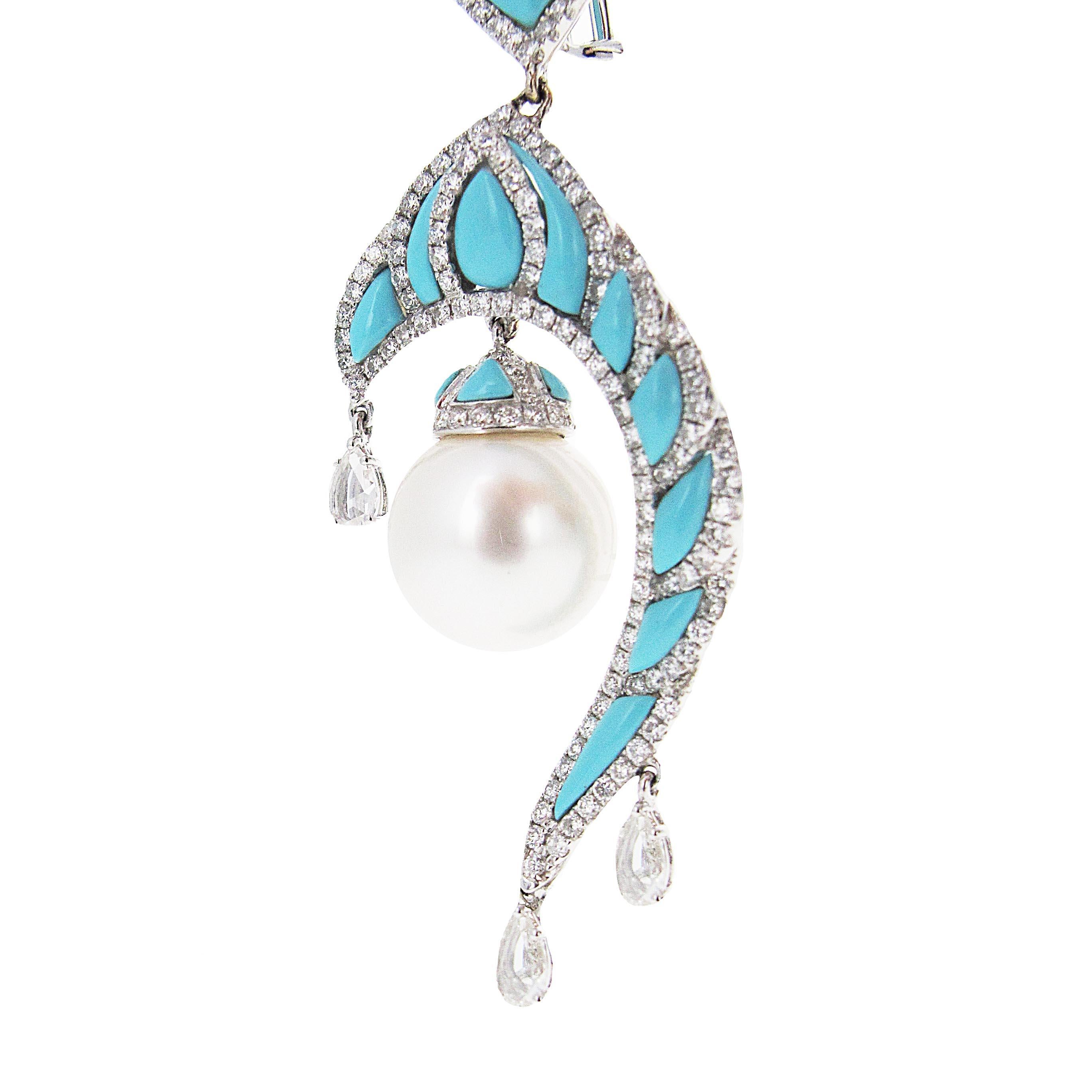 Look like a real princess. These 18k white gold turquoise, pearl and diamond earrings are extremely unique. We have only seen one other pair in pink (see other listing). These dangle beautifully below the ear and have such nice detail. There is a