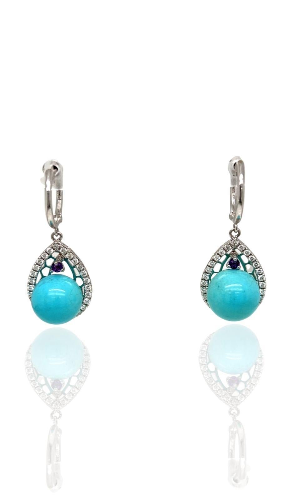 Serene turquoise earrings accented by 54 round diamonds at .53 ctw, VS-SI in clarity, H-I in color.  A .09 ctw amethyst adds color. Perfect for turquoise collectors or a birthday gift.  Appropriate for any occasion. Set in 3.5 grams of 14K white