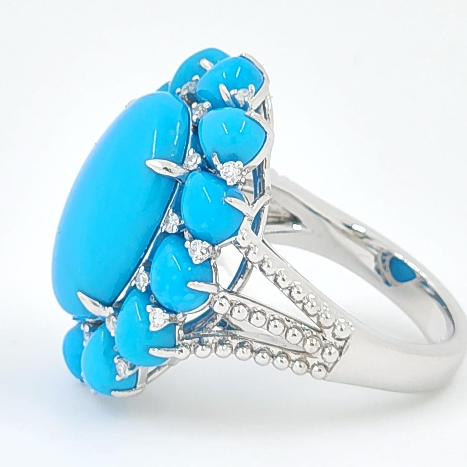 These photos does not do this piece justice ! This cluster ring features 5.81 carats of turquoise at the center, surrounded with 4.99 carats of pear shape turquoise on the side. Assented with 0.19 carat of white round diamonds. All the turquoises