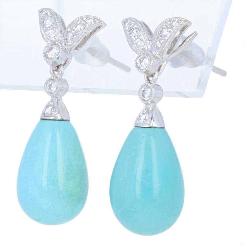 Metal Content: Guaranteed 18k Gold as stamped

Stone Information: 
Genuine Turquoise
Treatment: Routinely Enhanced 
 
Natural Diamonds  
Clarity: VS1 - VS2 
Color: F - G  
Cut: Round Brilliant
Total Carats: 0.24ctw 

Style: Dangle
Fastening Type: