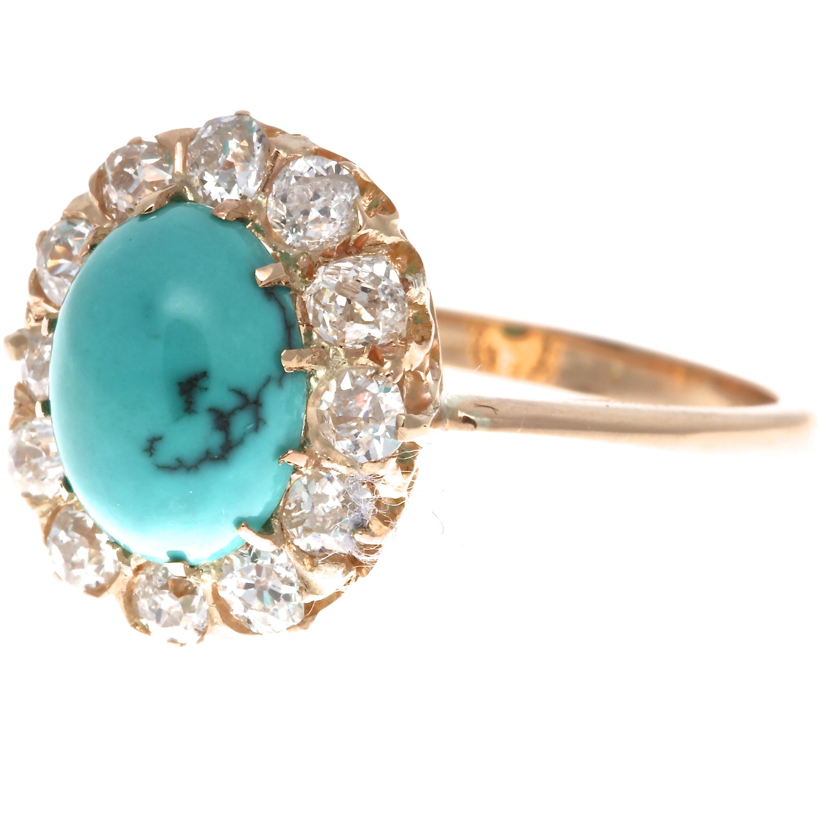 Stylishly timeless the halo ring has ingrained itself in jewelry as one of the most iconic creations. Featuring a vibrantly multihued bluish-green cabochon cut turquoise that is surrounded by a halo of old cut diamonds. Hand crafted in 18k gold.