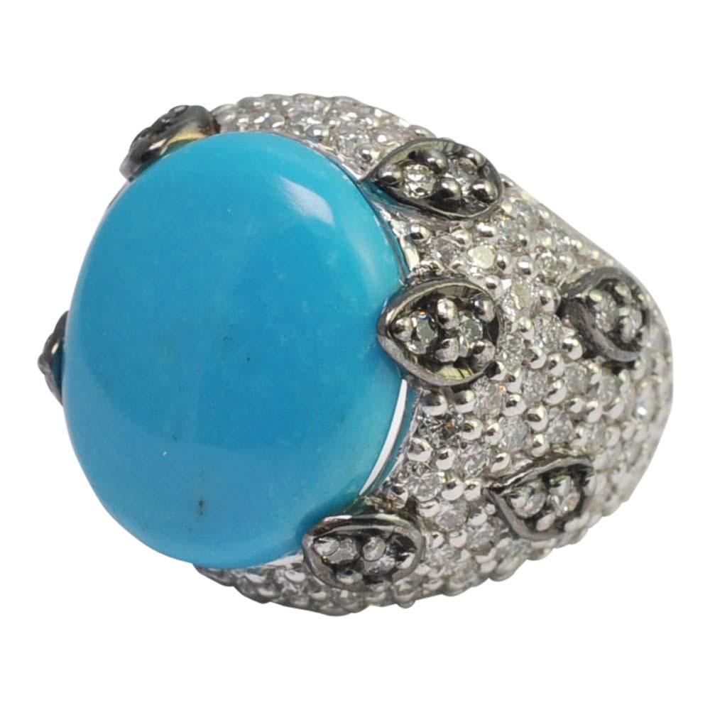 Huge statement ring!  Large 11ct oval turquoise mounted in a diamond micro pavé setting consisting of approximately 4cts of brilliant cut diamonds.  Some of the diamonds are randomly set in raised, black gold pear shapes, adding extra detailing to