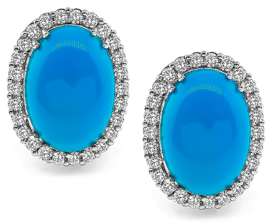 This elegant 14k white gold ring and earrings set features lovely cabochon turquoises. The turquoises are accentuated by sparkling round cut diamonds that weigh approximately 3.00ct. graded H-I color with VS2 clarity. The earrings measure 23mm by