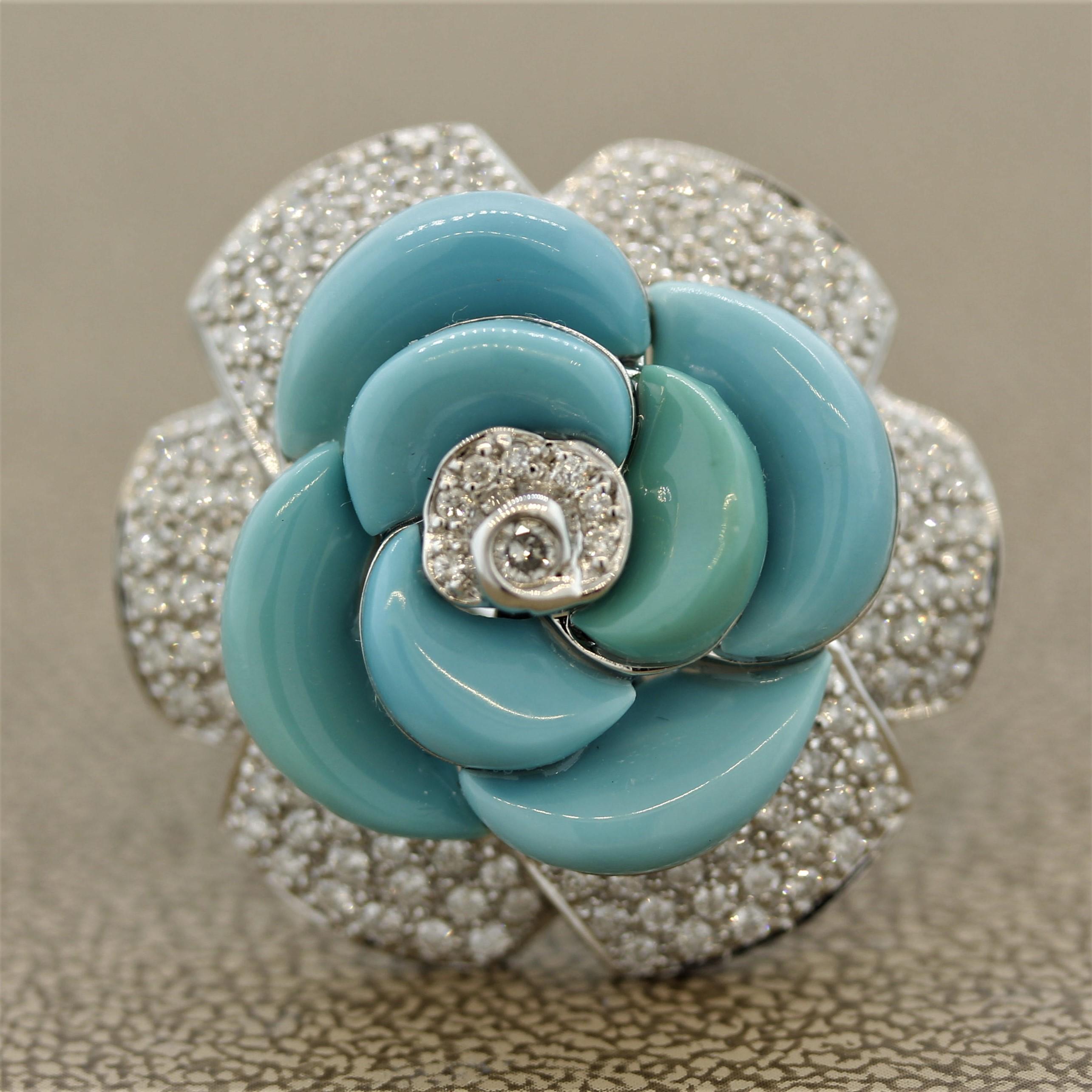 A large and impressive cocktail ring of a flower. It features 7 pieces of natural turquoise set as the flower’s petals along with 1.13 carats of round cut diamonds, which are pave set around the flower. Made in 18k white gold and ready to bring life
