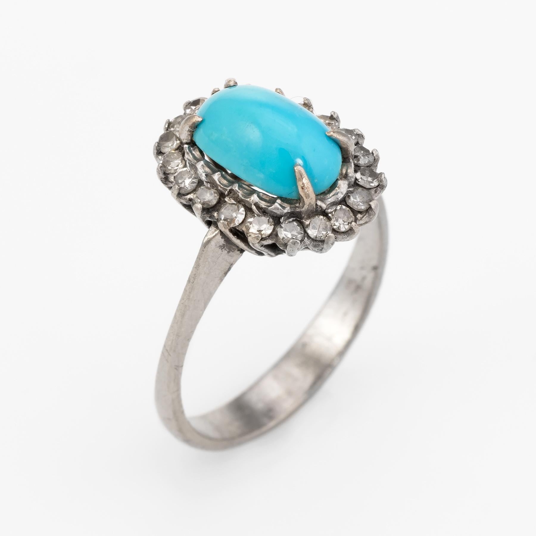 legant vintage cocktail ring (circa 1950s to 1960s), crafted in 14 karat white gold. 

Cabochon cut turquoise measures 9.75mm x 6mm (estimated at 1.75 carats), accented with 20 x 0.02 estimated single cut diamonds. The total diamond weight is