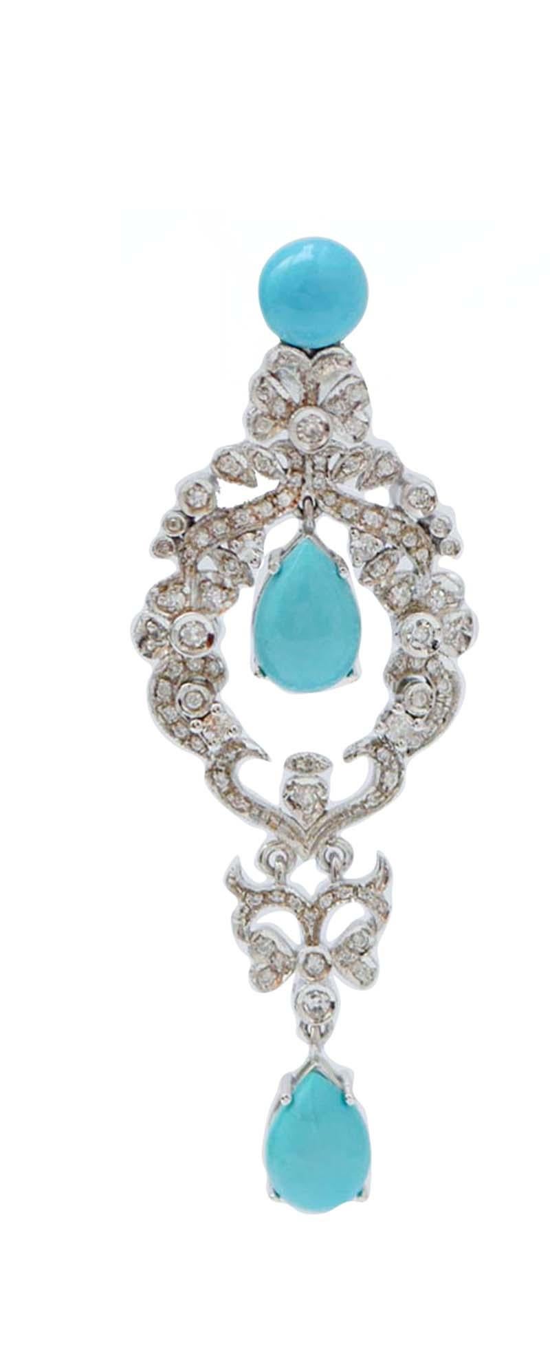 Amazing earrings in 14 kt white gold structure composed by a frame of diamonds. On of it, in its central pendant and as pendant, a turquoise.
These earrings were totally handmade by Italian master goldsmiths and they are in perfect