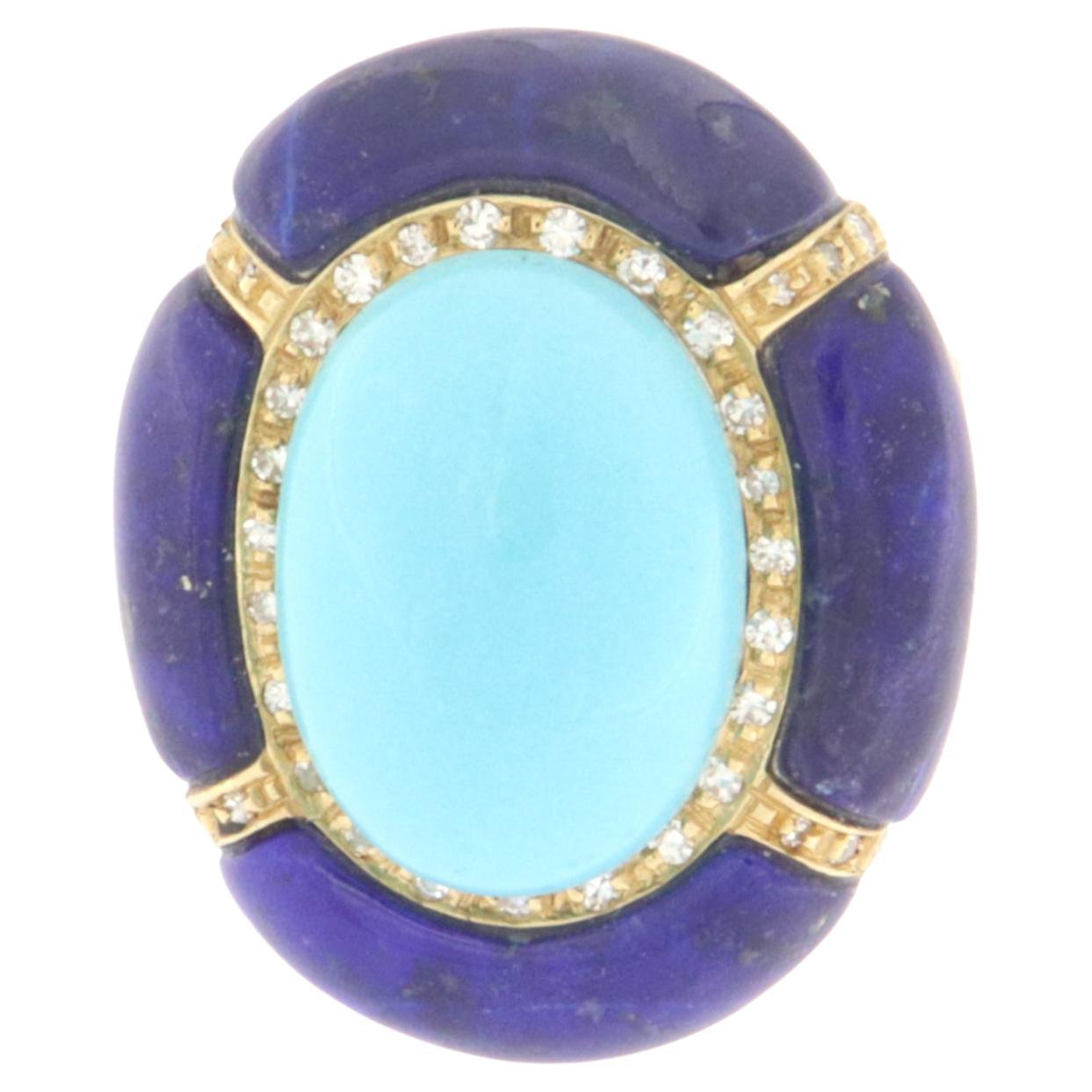 Fantastic ring made of 18 karat yellow gold with natural diamonds surrounding it on yellow gold and natural oval cut turquoise in the center,and lapis lazuli around,  entirely handmade by expert craftsmen in the sector.  The designer from the