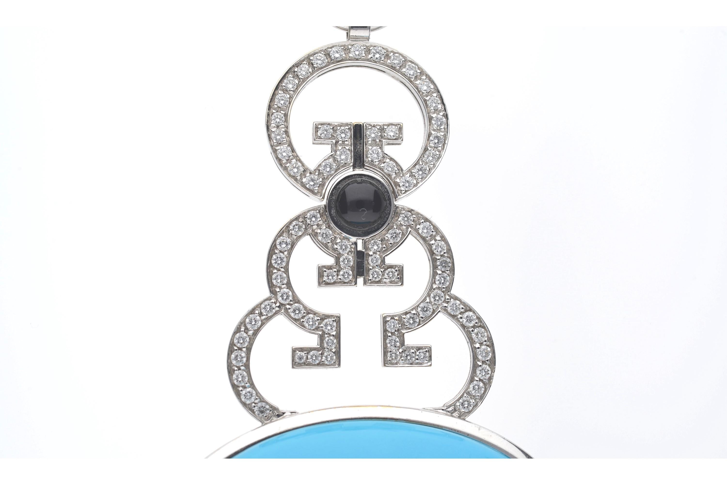 Pendant with Cabochon Cut Oval Turquoise with Diamonds and Cabochon Cut Sapphire, with Silk Cord Stopped by a Ball in Onyx and 18 Kt White Gold. 
Hook Closure in 18 Kt White Gold and Two Onyx Balls. 
Italian Manufacture. 
•SINGLE  PIECE.

•THE