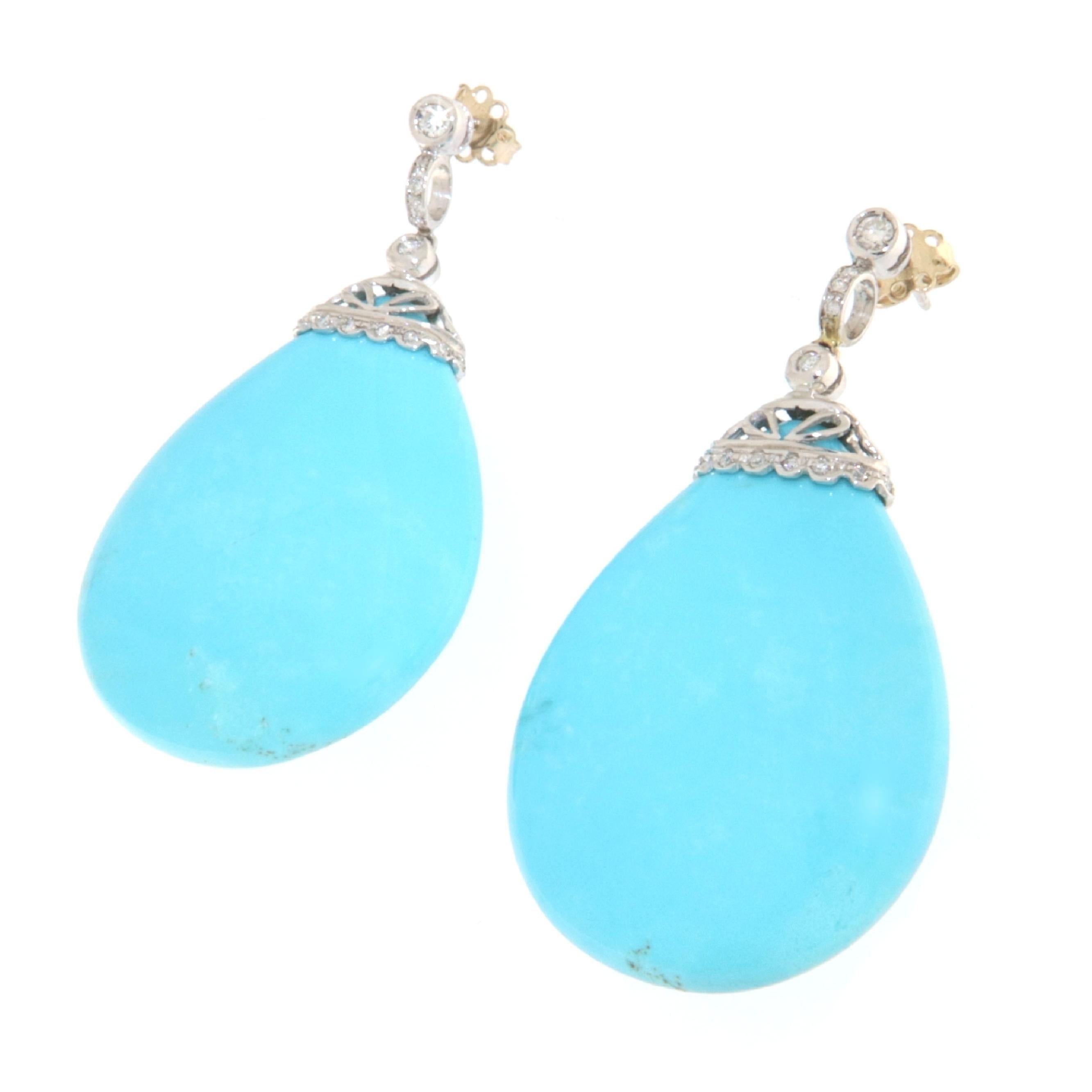 Stunning long pendant earrings in 18-karat white gold made entirely by hand, with maxi drops of natural turquoise and essential and precious diamonds mounted on a crown, with a pin and butterfly back. Precious, intense, very elegant, a one-of-a-kind