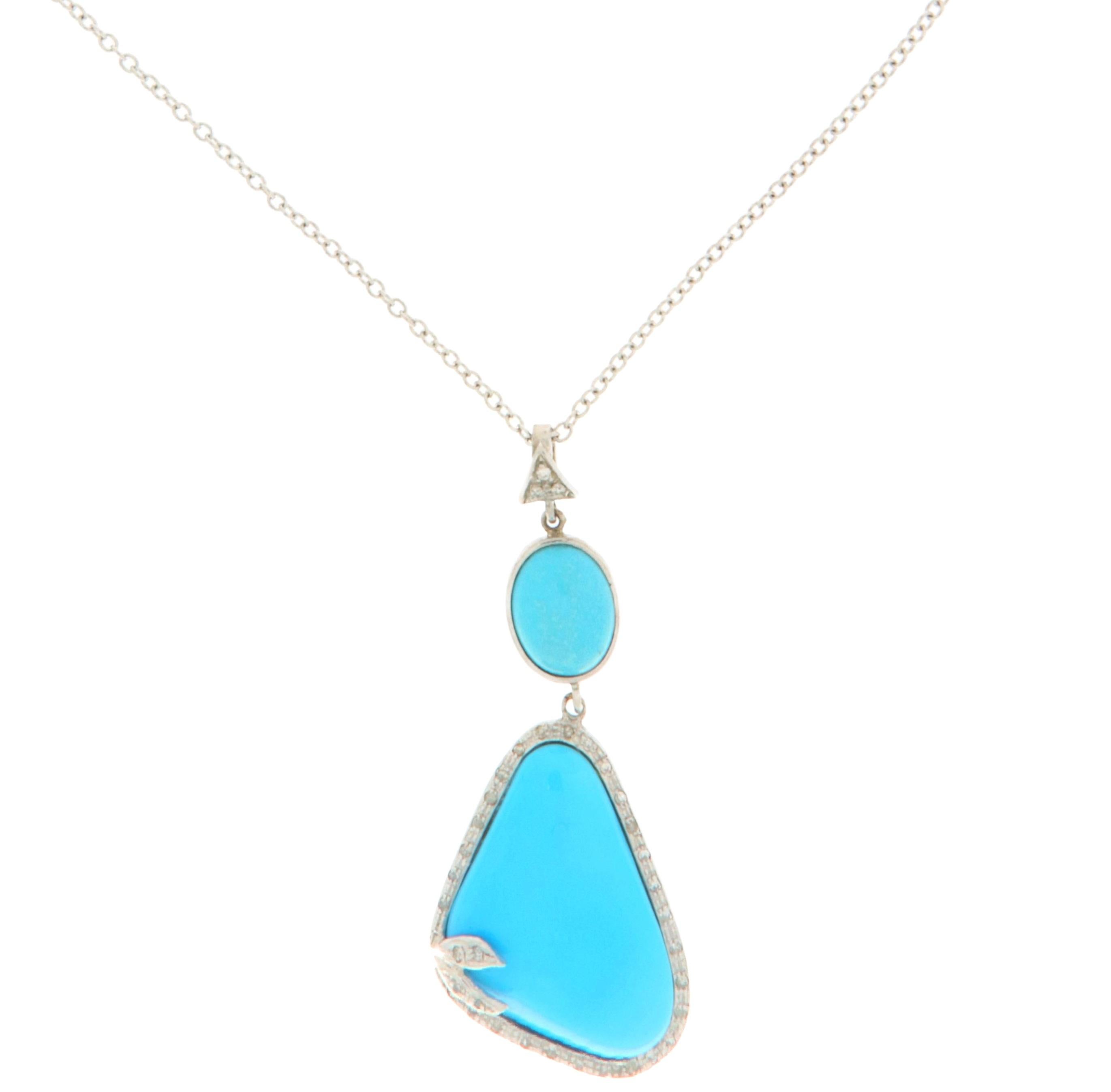 Unveil the beauty of contemporary elegance with this captivating pendant necklace in white gold 18 Karat , a stunning blend of gemstones. The centerpiece of this necklace is an irregularly shaped turquoise, radiating a vivid and refreshing blue hue