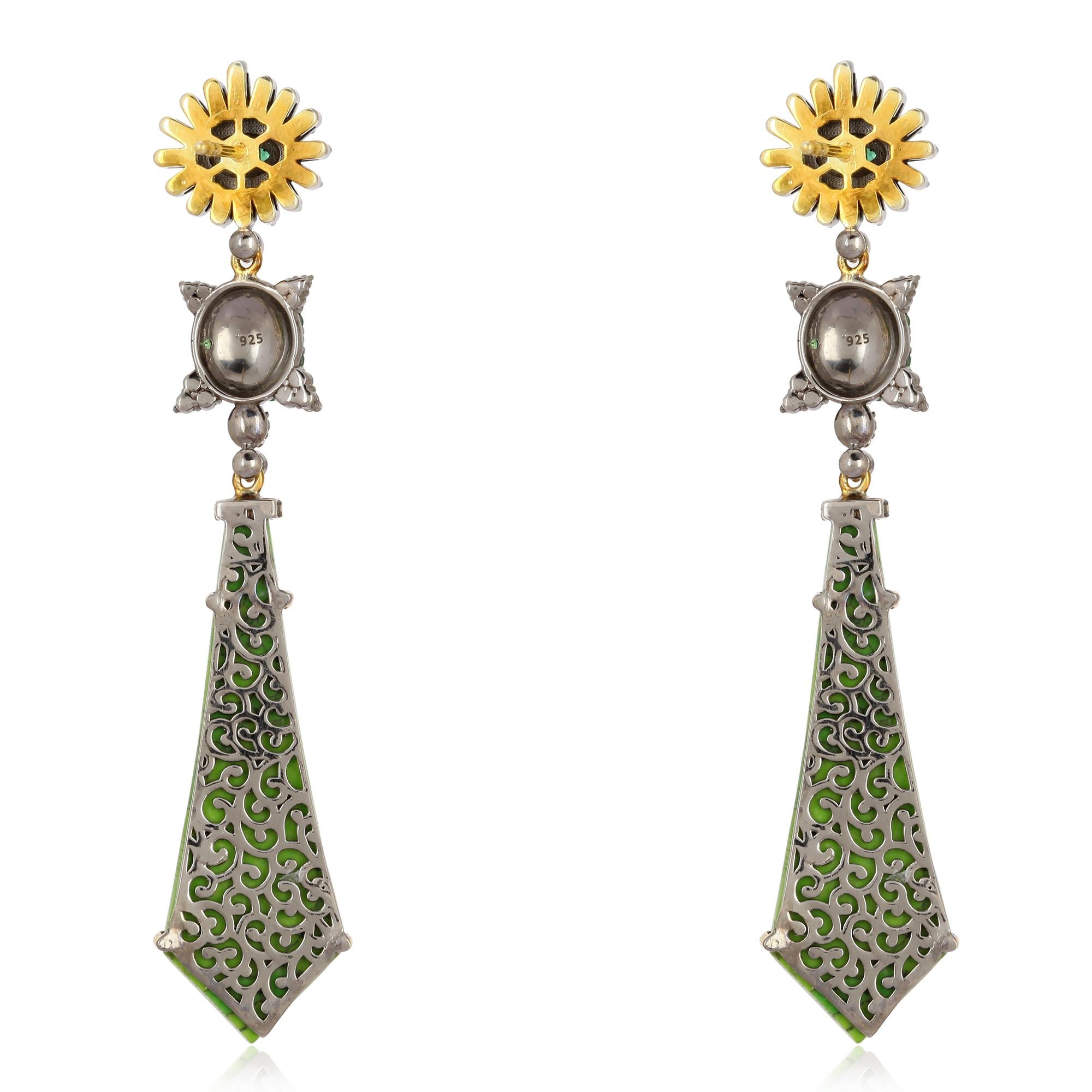 These beautiful earrings are meticulously crafted in 18-karat gold and sterling silver. It is set in 16.52 carats turquoise, .38 carats Emerald, .70 carats tsavorite and .79 carats of diamonds. 

FOLLOW  MEGHNA JEWELS storefront to view the latest