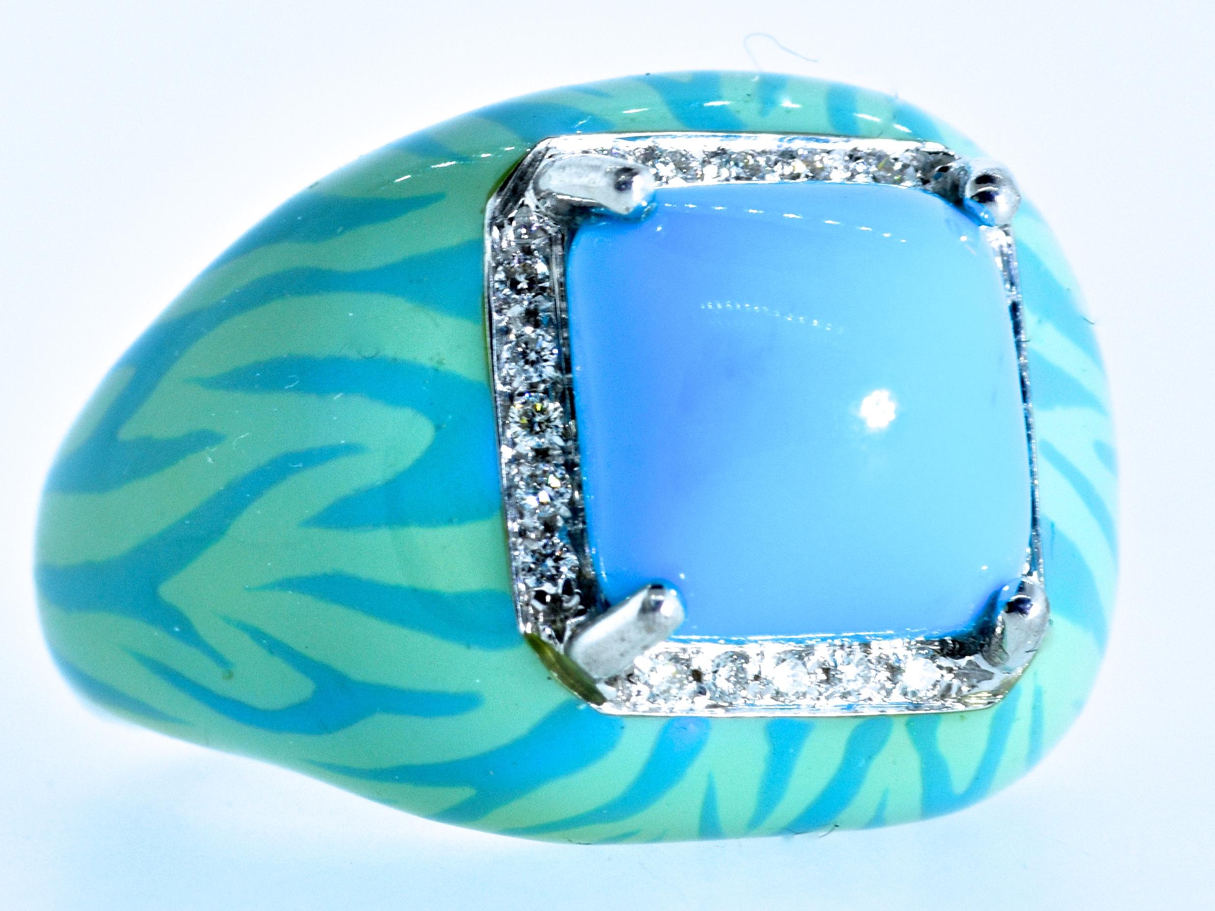 Turquoise, fine and natural and displaying a pleasing bright robin's egg blue color.  This prong set center stone is a high sugar-loaf cabochon.  20 fine white brilliant cut diamonds, all well cut and well matched, near colorless (G) and very very