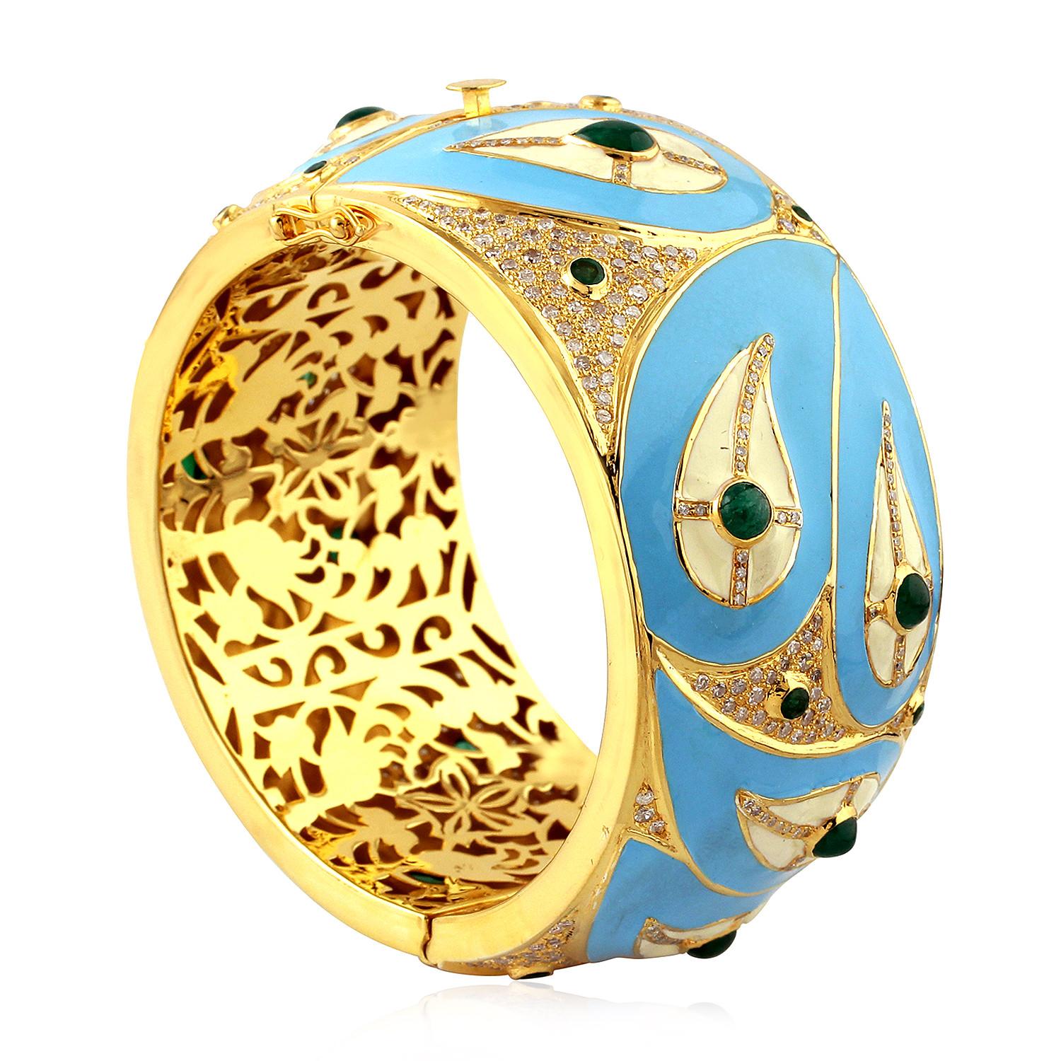 Stylish and forever this paisley design turquoise enamel openable bangle with diamonds and emeralds is a classic piece. This bangle is made in 18k yellow gold and silver, and can be opened on side and has safety clasps on both the sides.

18k: