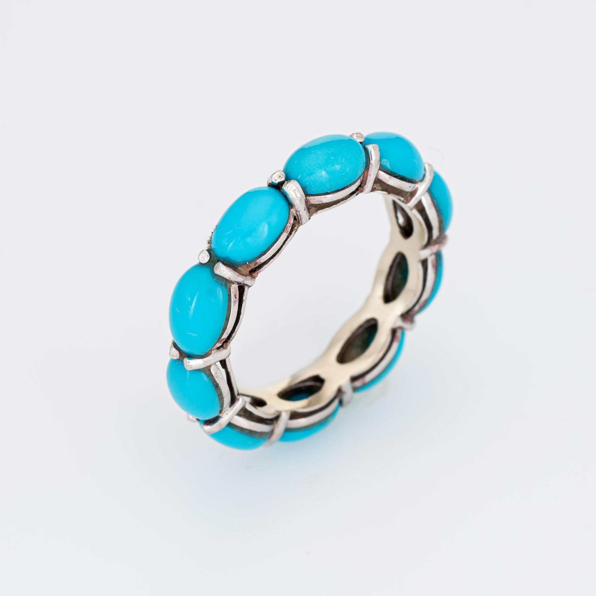 Stylish estate turquoise eternity ring crafted in 14 karat white gold. 

10 pieces of cabochon cut turquoise is estimated at 0.50 carats each and total an estimated 5 carats. The turquoise is in excellent condition and free of cracks or chips. 

The