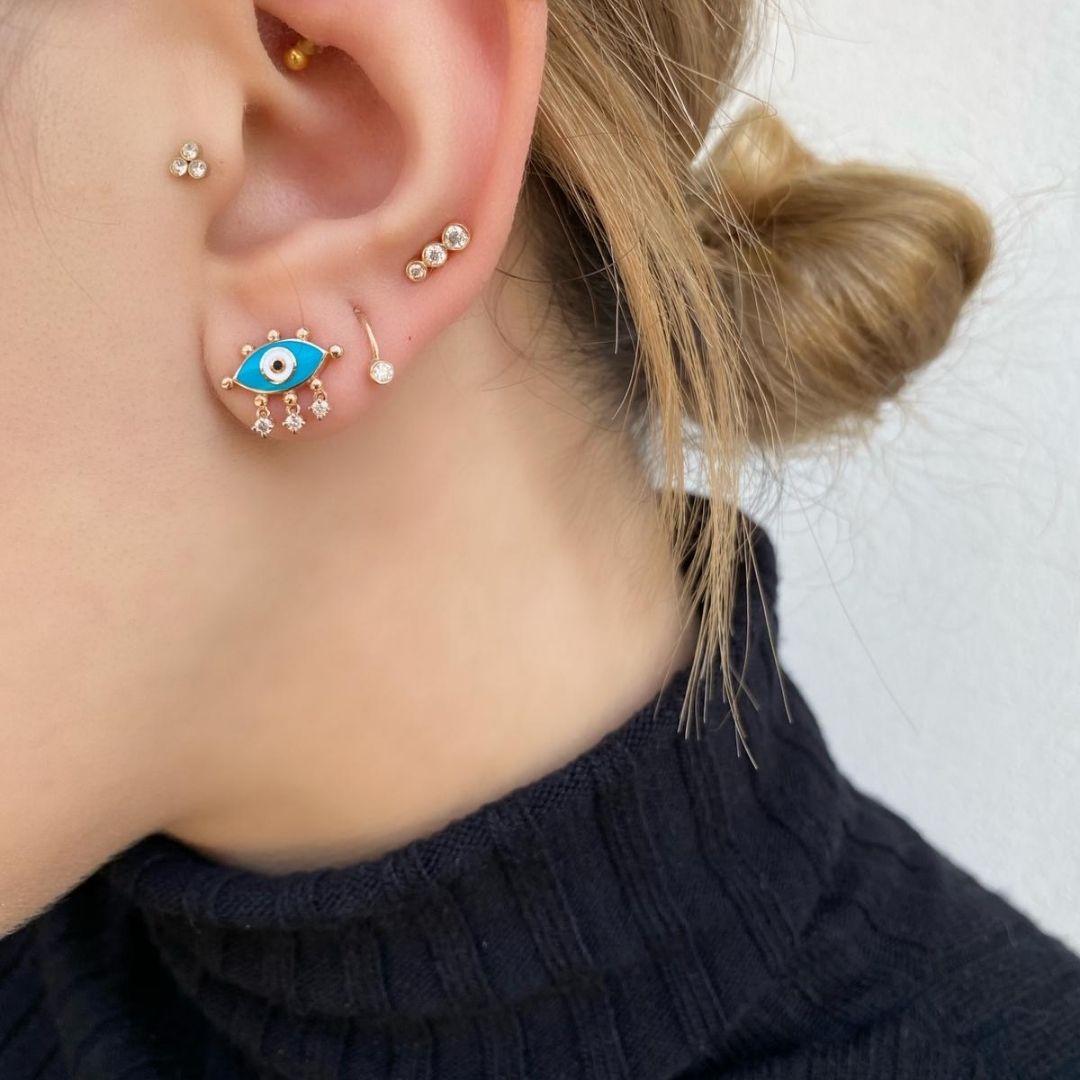Turquoise evil eye hoop earring (single) with 14k rose gold by Selda Jewellery

Additional Information:-
Collection: Art Of Giving Collection
14k Rose gold
0.08ct White diamond