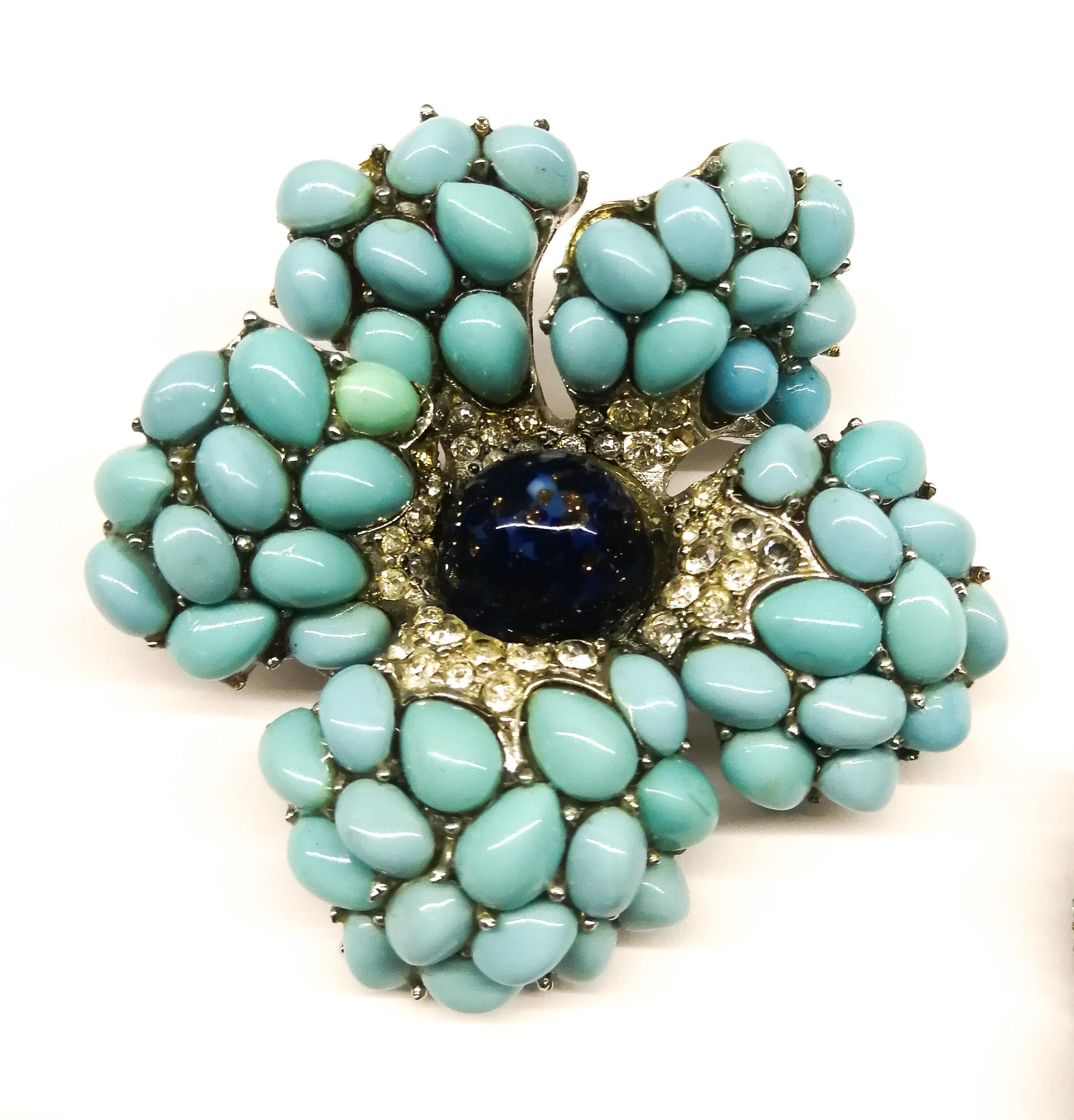 A beautiful stylised floral brooch and matching 'cluster' earrings, with turquoise cabochons, and a large lapis 'bullet' cabochon at the centre of each jewel, highlighted all round with clear pastes. Echoing designs from Cartier and Van Cleef And