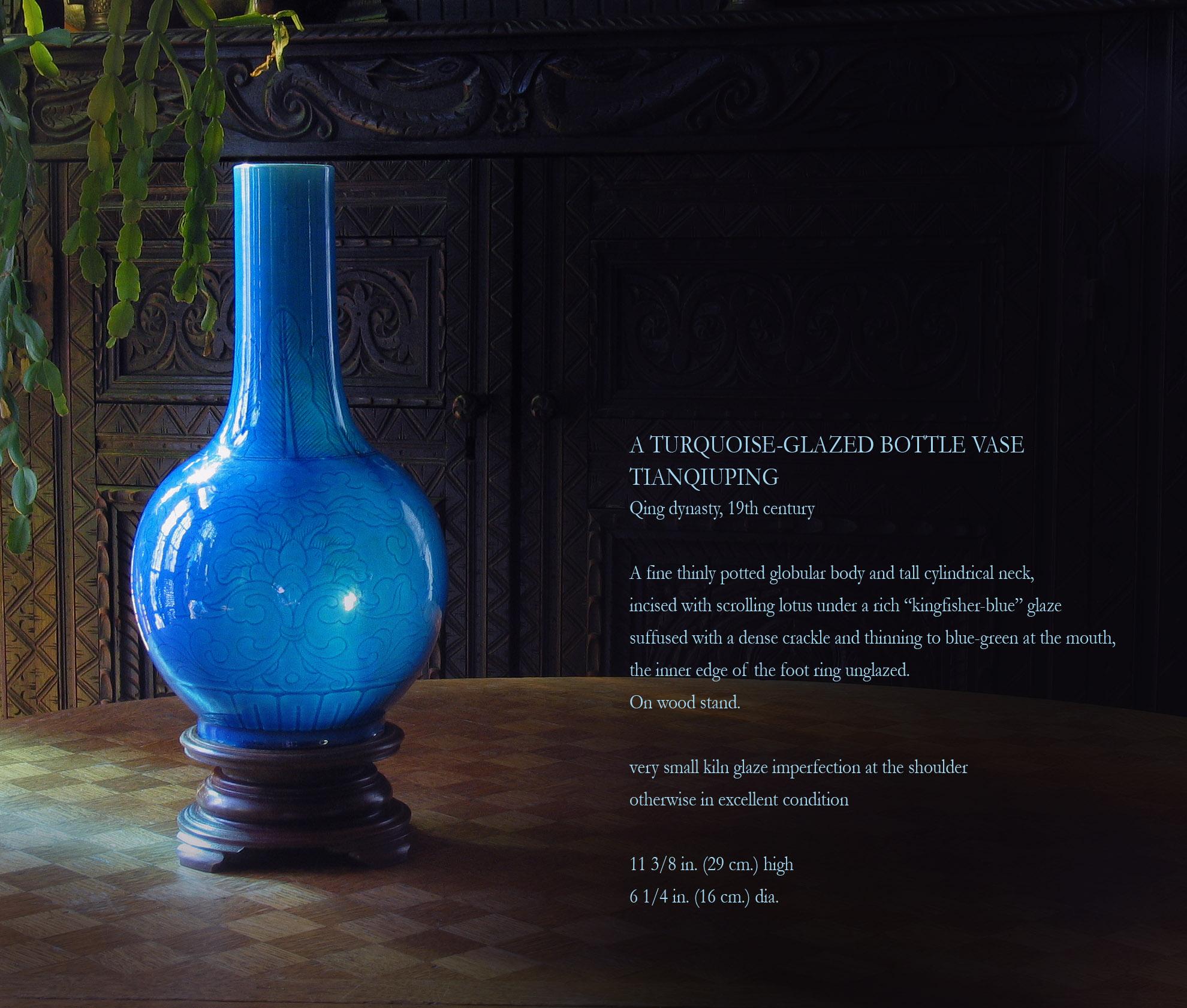 A Turquoise-Glazed bottle vase
Tianqiuping
Qing dynasty, 19th century.

A fine thinly potted globular body and tall cylindrical neck, 
incised with scrolling lotus under a rich “kingfisher-blue” glaze
suffused with a dense crackle and thinning