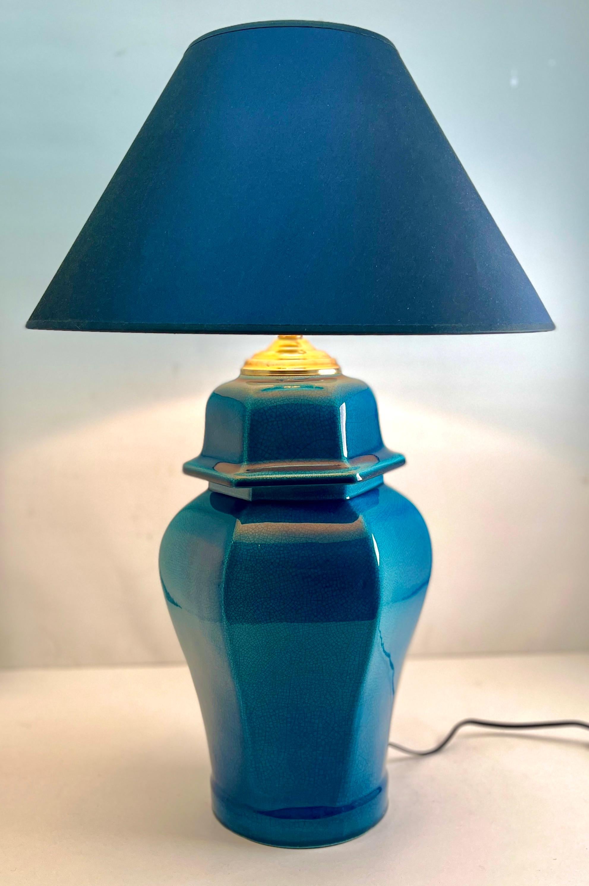 Inspired by a centuries-old technique of Chinese ceramics, this elegant table lamp is a bright and dramatic shade of turquoise with a fine crackle glaze. 
The dimensions are measured without a lampshade.

Renewed and rewired with pedestal lamp