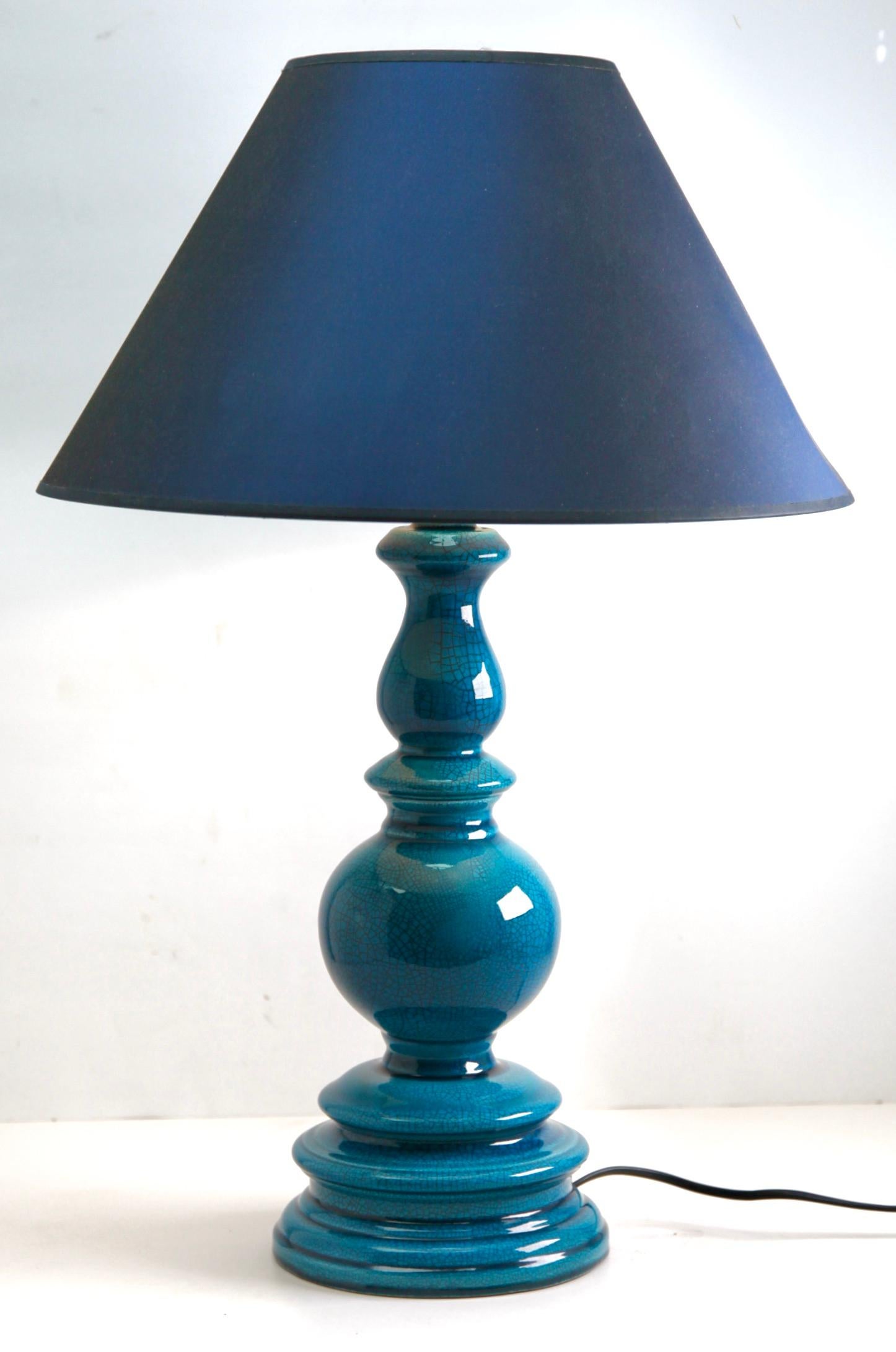 Inspired by a centuries-old technique of Chinese ceramics, this elegant table lamp is a bright and dramatic shade of turquoise with a fine crackle glaze. 
The dimensions are measured without a lampshade.

Renewed and rewired with lamp fitting