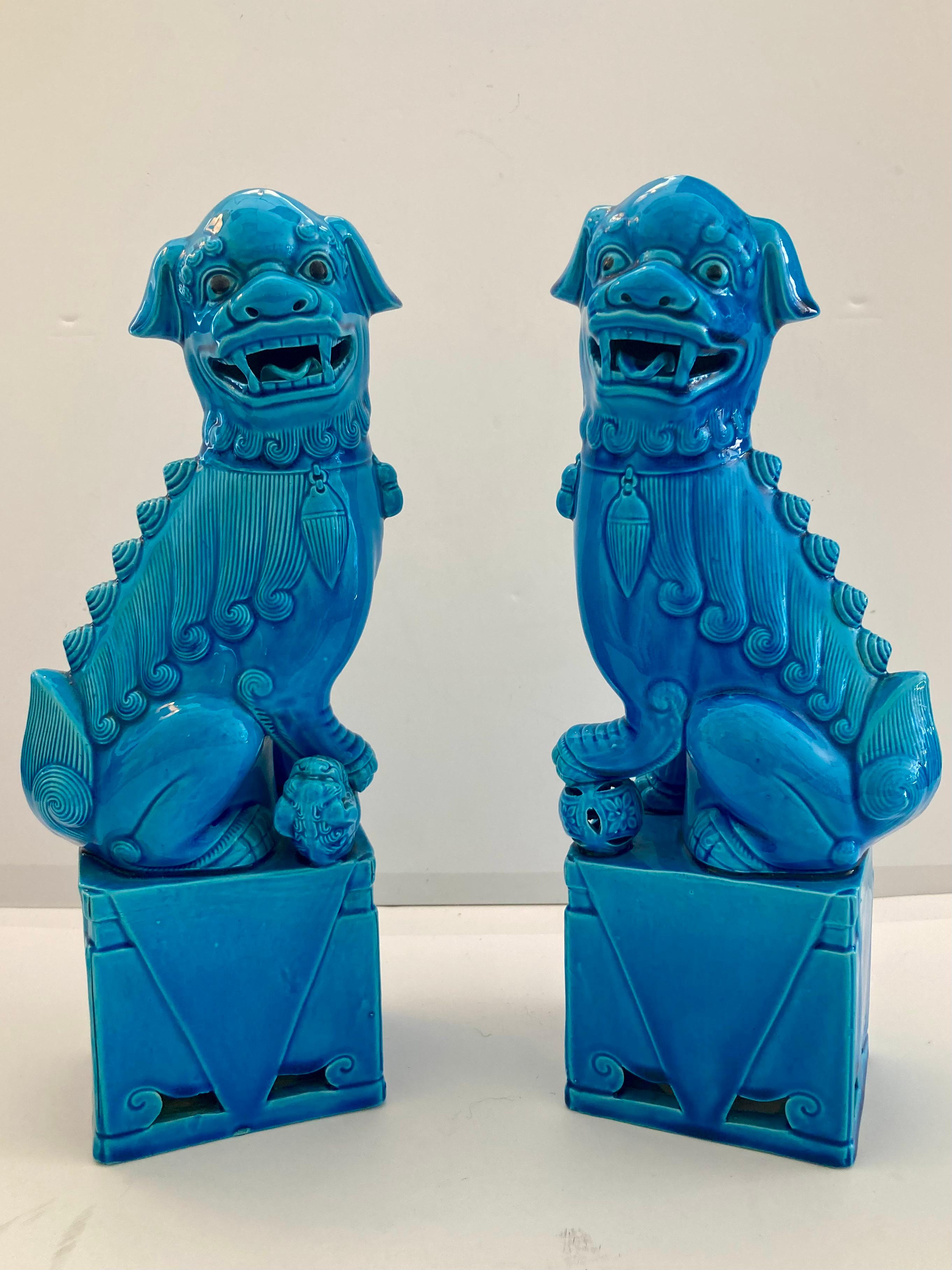Pair of turquoise glazed porcelain foo dogs. Large size and beautiful details. Add some classic Asian style and amazing color to your home.