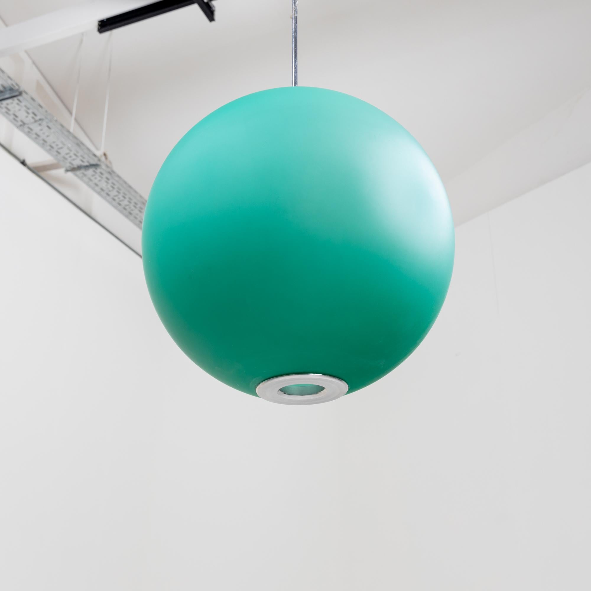 Large globe-shaped ceiling lamp made of turquoise glass on a long chromed rod. Label by Fontana Arte on the inside.