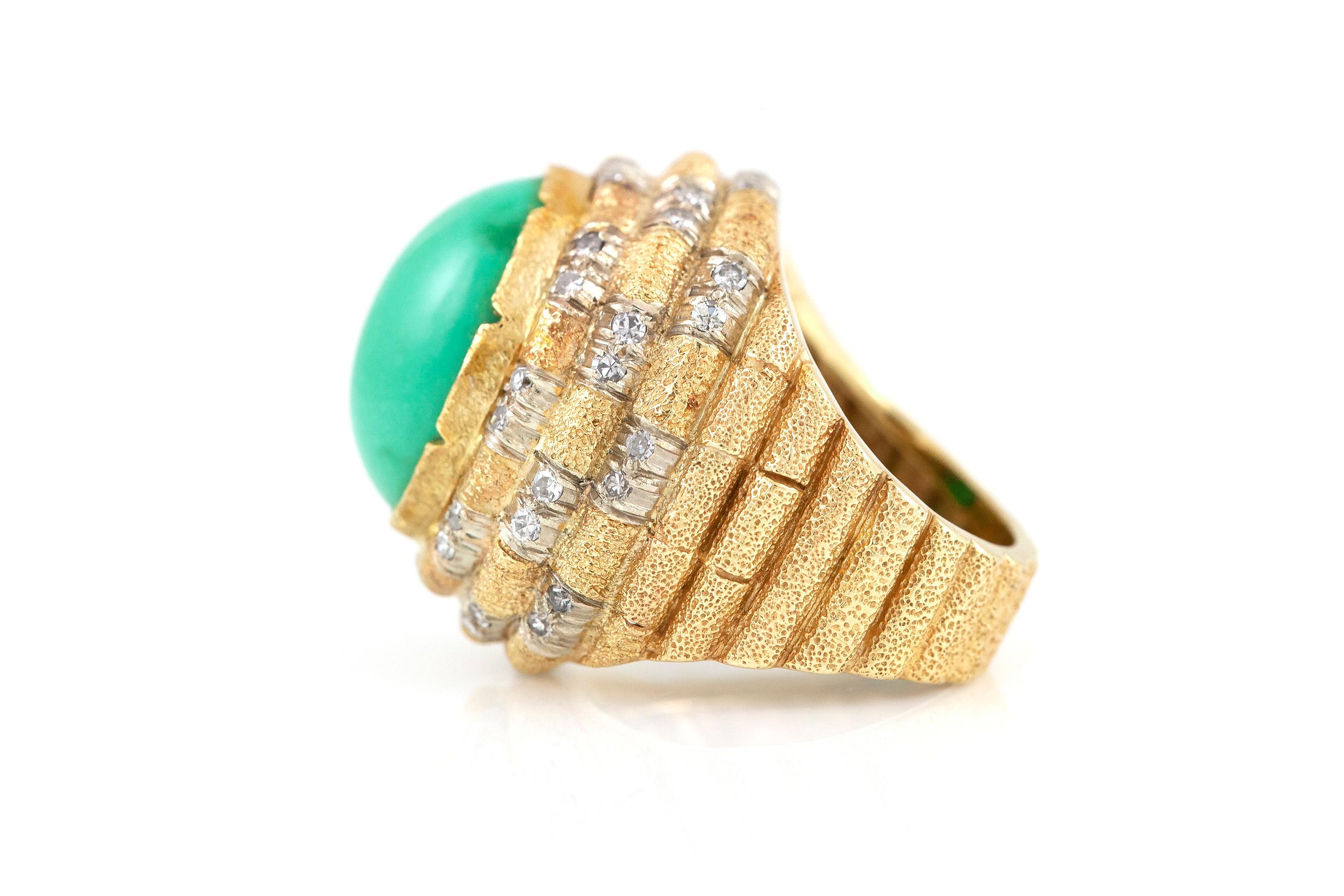 Cocktail ring finely crafted in 14k gold, weighing a total of 12.8 dwt, with a center turquoise stone, and diamonds weighing 1.00 karat. Circa 1980.
