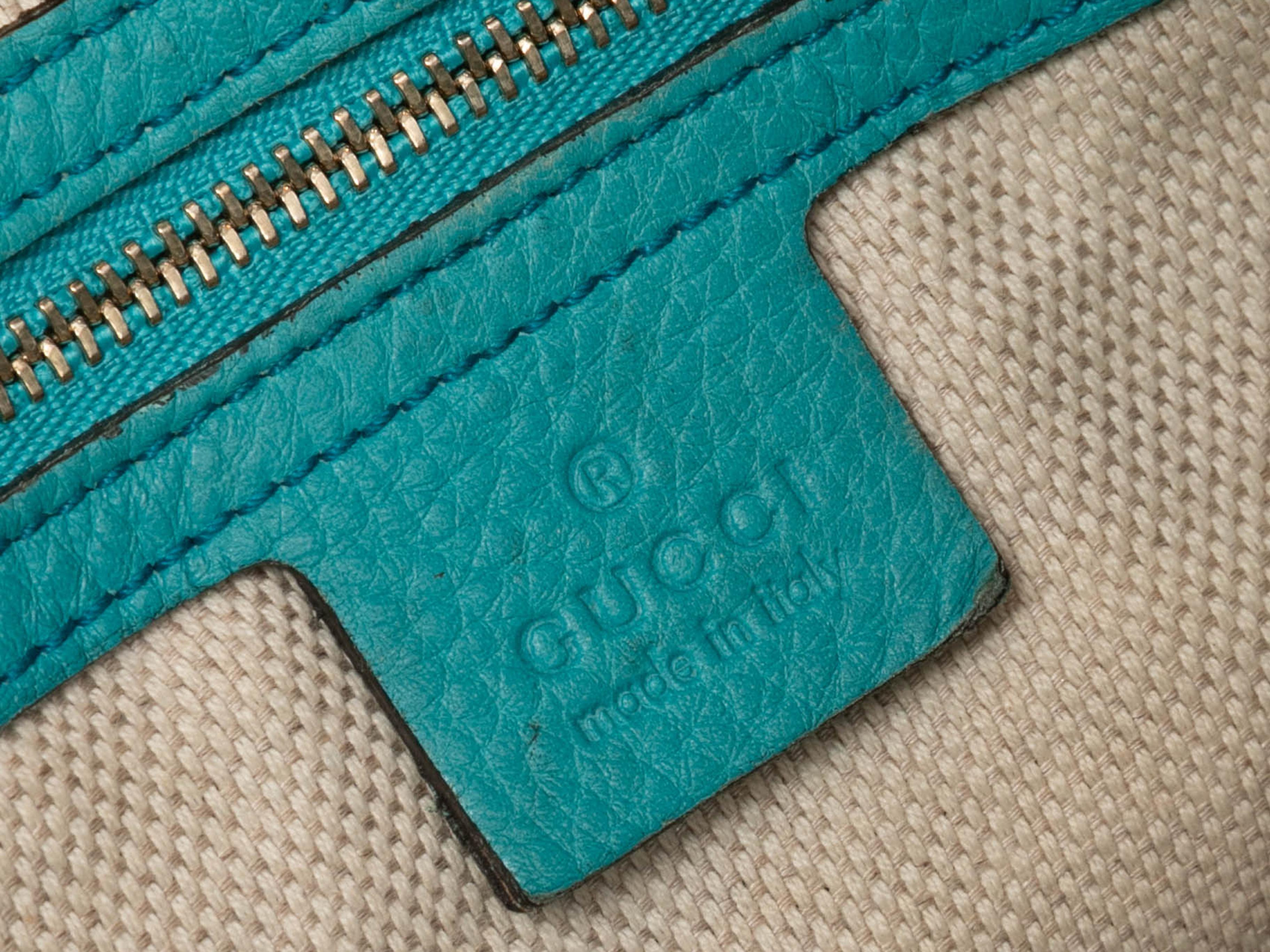 Turquoise Gucci Leather Soho Hobo Tote. The Soho Hobo Tote features a leather body, silver-tone hardware, front logo embroidery, and dual chain-link and leather shoulder straps. 18