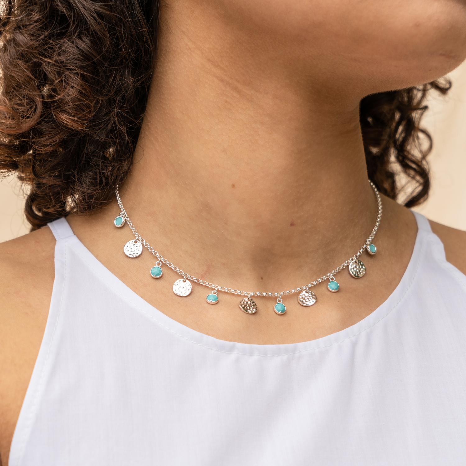 A modern take on traditional opulence, this sterling silver necklace teams 6 gorgeous turquoise drops alongside 5 hammered discs. The necklace stands out effortlessly and pairs beautifully with sun-kissed skin. The necklace is on a sterling silver
