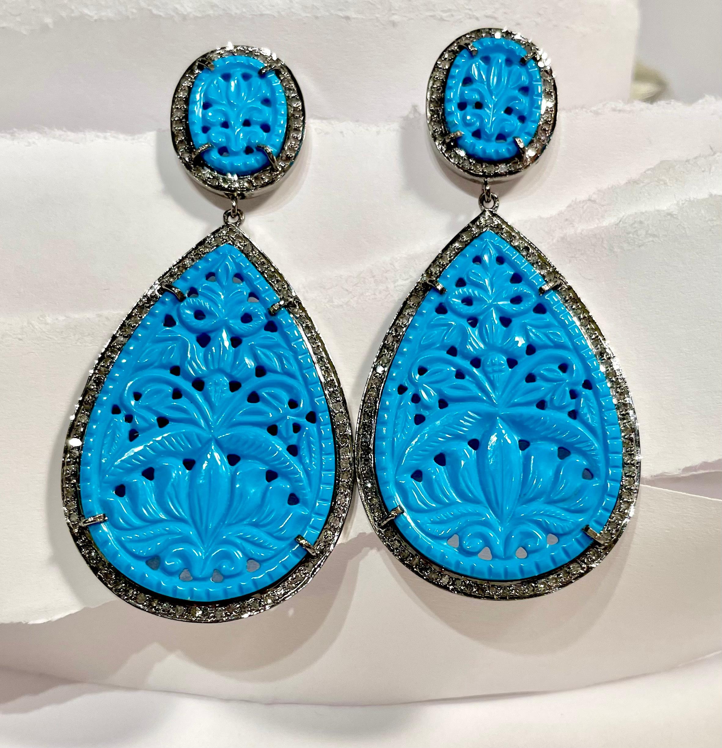 Description
Vibrant, striking and fun hand-carved Turquoise earrings framed with pave diamonds. 
Item # E3224

Materials and Weight
Turquoise, 30 x 40mm pear shape, 57 carats.
Pave diamonds 1.5 carats
Posts with jumbo backs, 14k yellow gold 
Rhodium