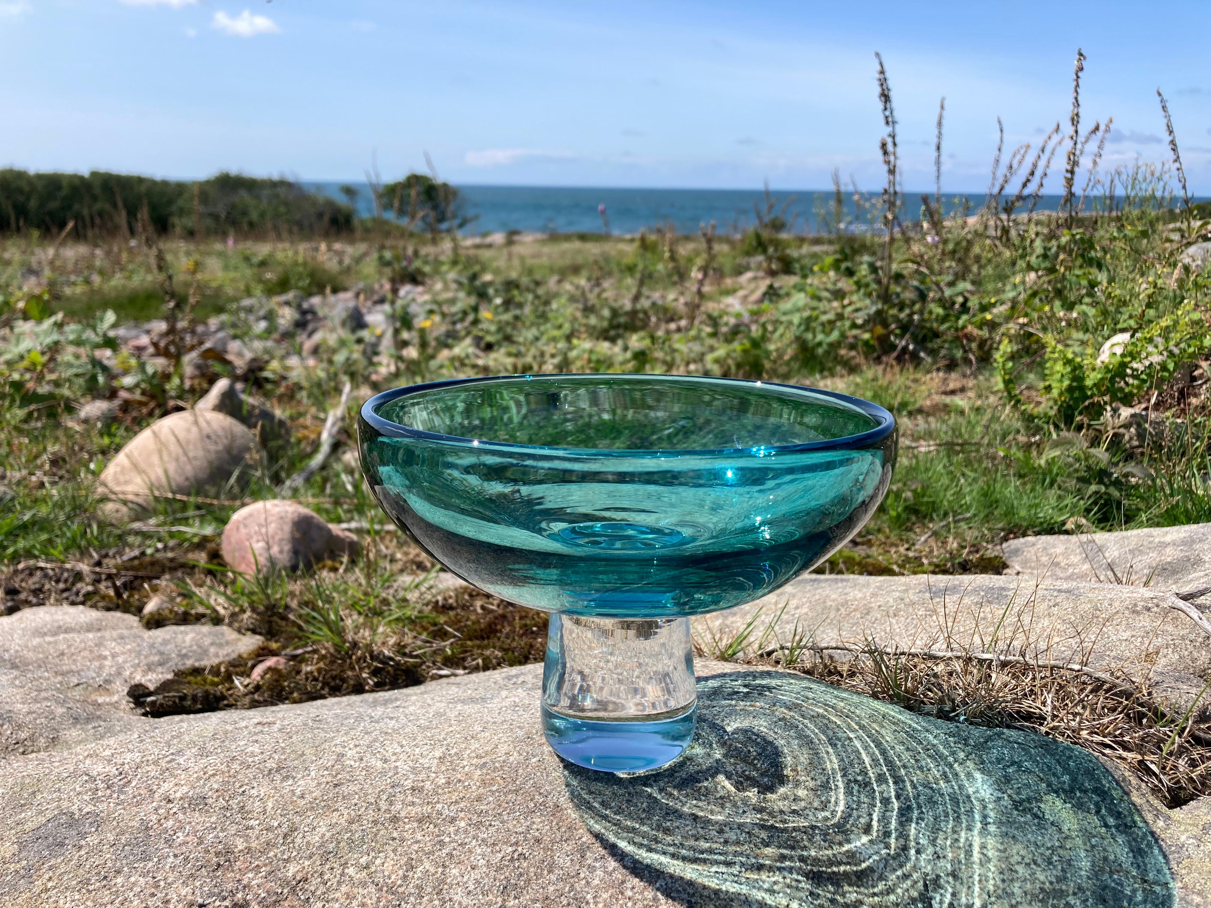 This vintage art glass pedestal bowl is unsigned but is presumed to have been made by the famous Swedish glassmaker Kosta Boda. It has the typical clean lines of a mid-century Scandinavian art glass piece and most likely dates from the 1950/60s.