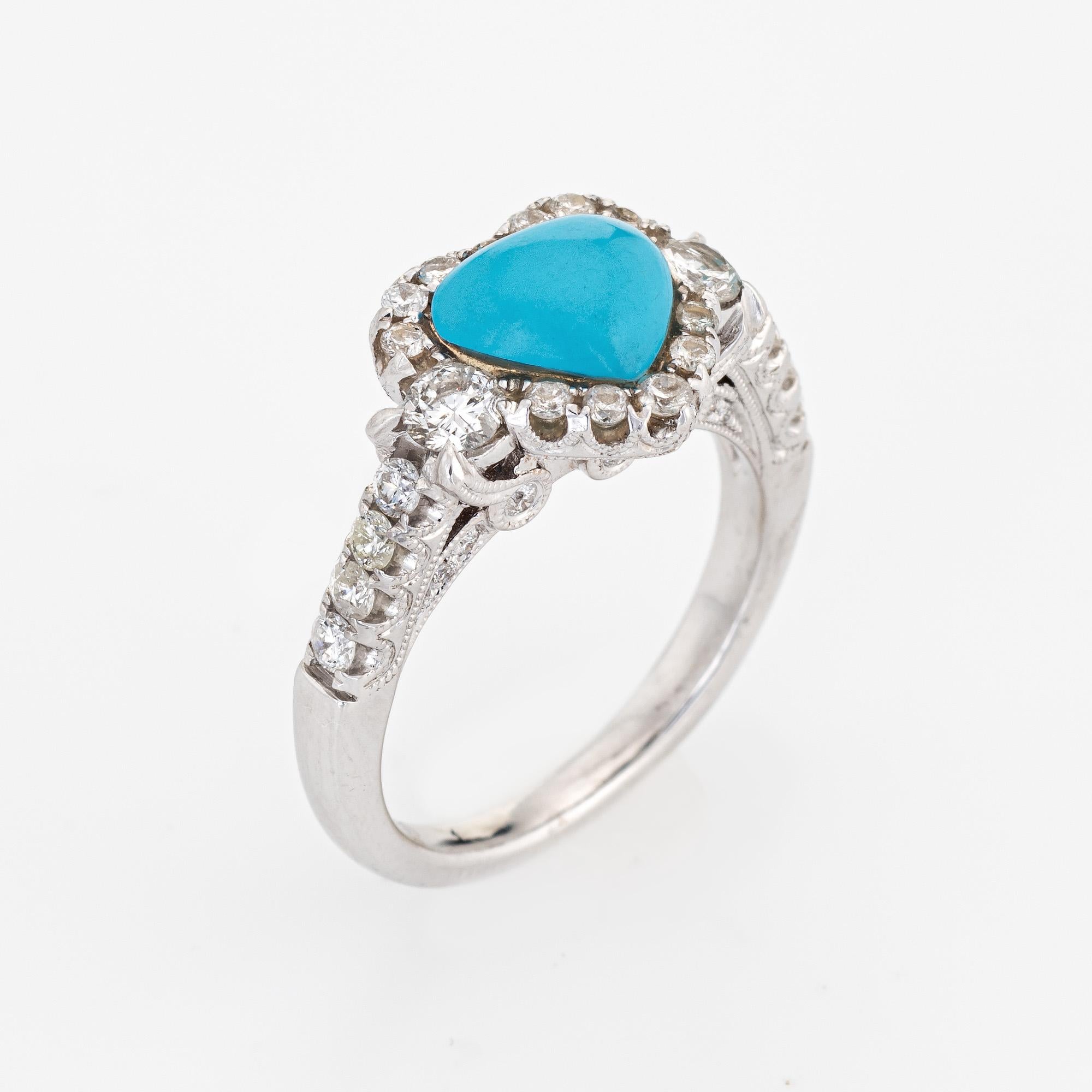 Stylish turquoise & diamond heart ring (circa 2000s) crafted in 18 karat white gold. 

Cabochon cut heart shaped turquoise is estimated at 1.75 carats. Round brilliant cut diamonds total an estimated 1 carat (estimated at H-I color and VS2-SI2
