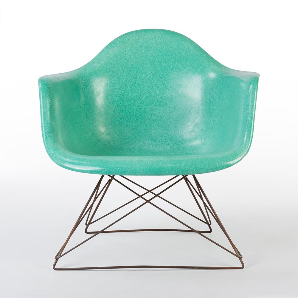 A very special find. Here we have an all original Eames Herman Miller turquoise LAR lounge chair. Not only is the chair comprised of an original 'Cats Cradle' base it's shell is also finished in the very rare turquoise colour which is rarely seen!