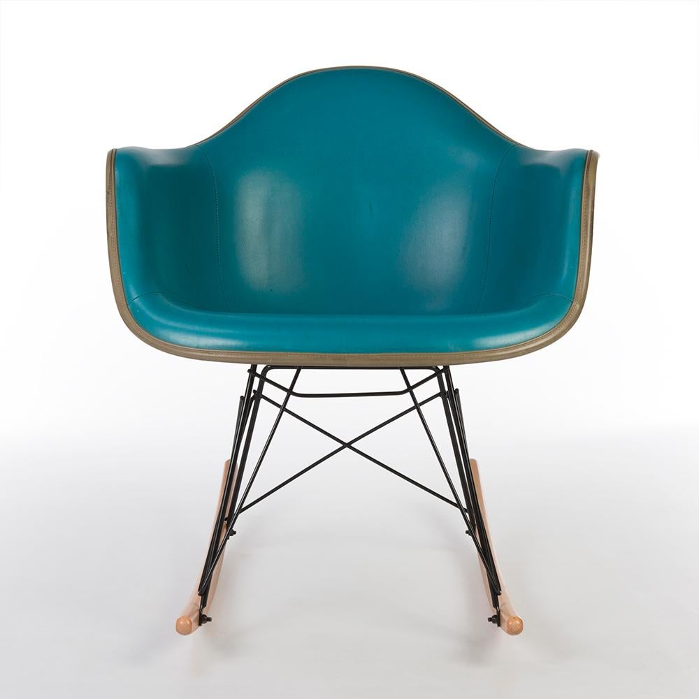 A little used, but stunning example of an original Eames Herman Miller RAR rocking chair. Finished in gorgeous turquoise naugahyde vinyl which is, sadly, a little more used than usual with some slight burn marks in it, this shell is a truly great