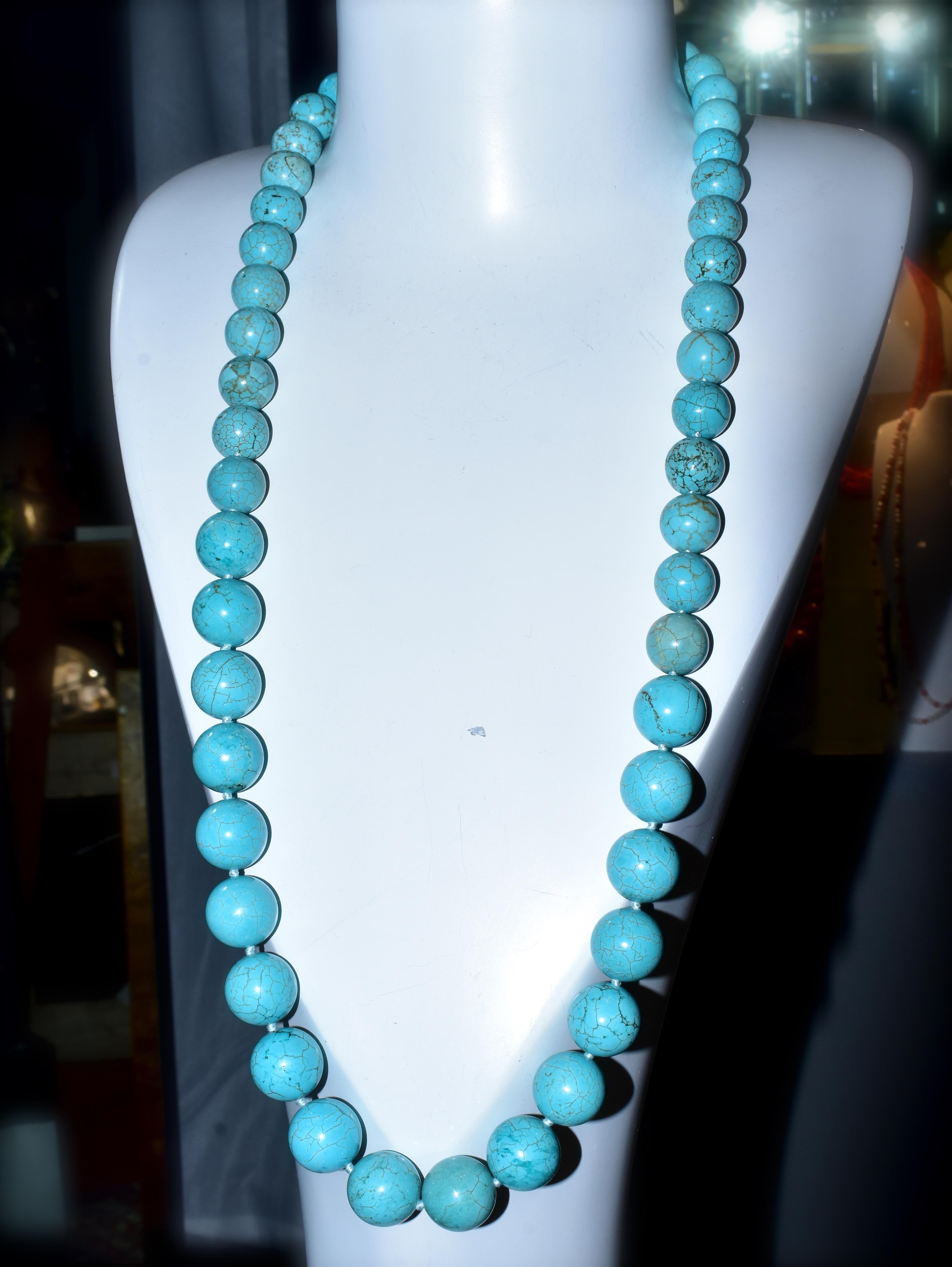 Tibetan natural turquoise, 50 round beads displaying a pleasing medium blue, robin's egg blue, with natural spider like webbing.  This 35 inch strand was recently restrung, a well made 12 mm. gold clasp finished the necklace.  The natural turquoise