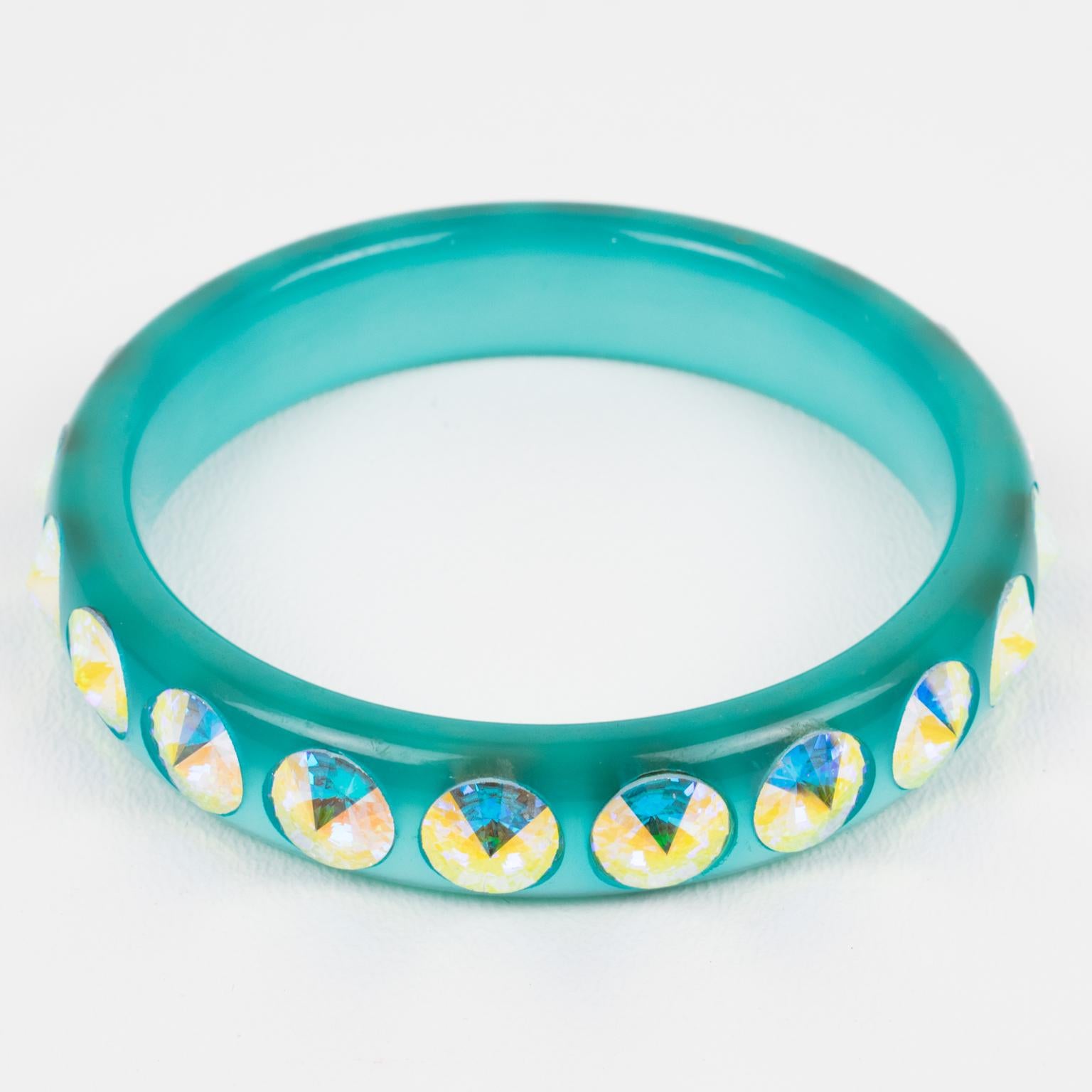 This gorgeous Lucite bracelet bangle features a domed shape in a turquoise blue color. The bangle is ornate with massive Aurora Borealis AB glitter crystal rhinestones. There is no visible maker's mark.
Measurements: Inside across is 2.57 in