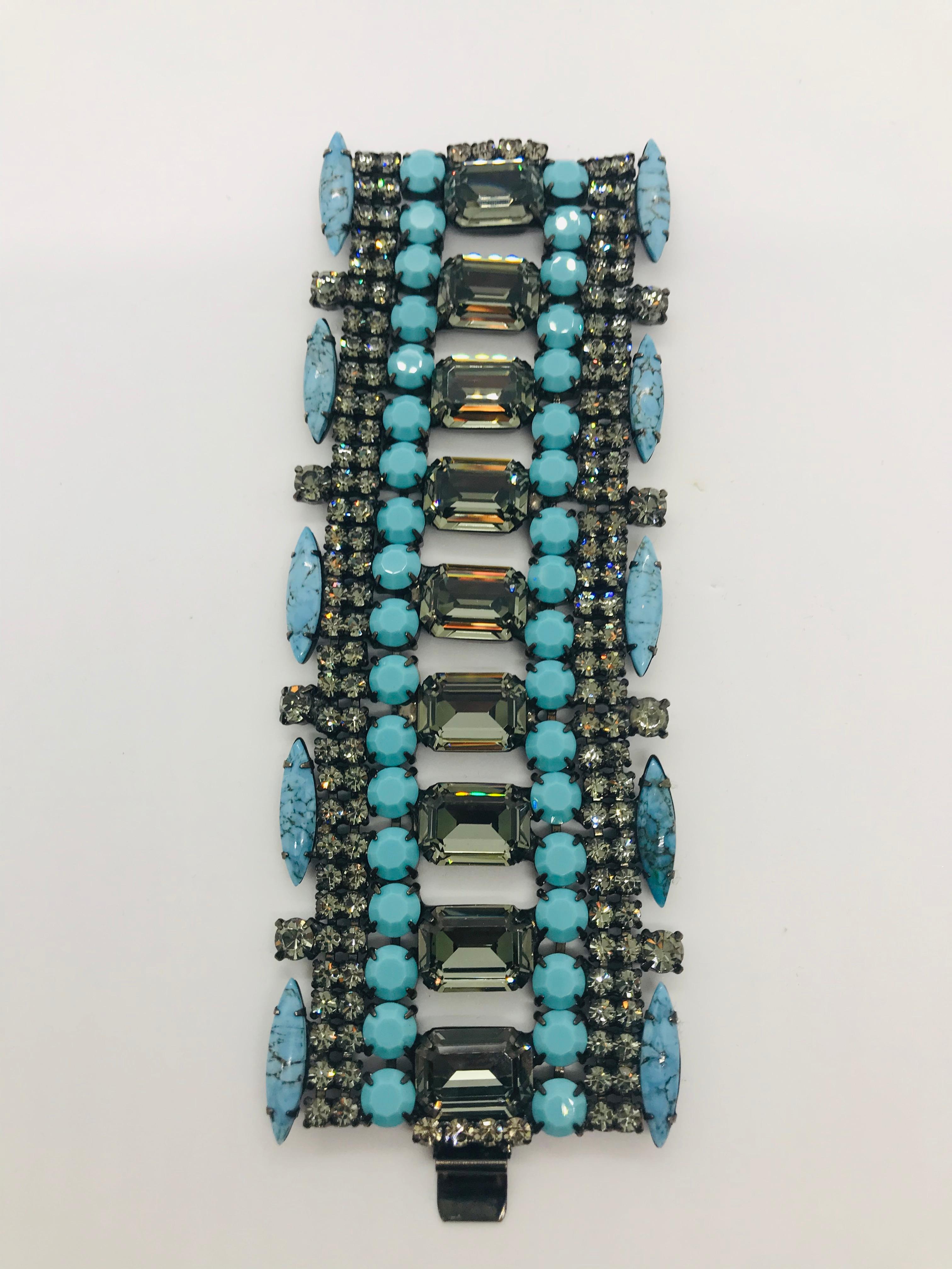 This bold turquoise matrix and black diamond Austrian crystal flex cuff bracelet is a versatile cuff featuring 1970s Swarovski black Alaskan diamond octagon stones running through its center.  It is edged in 1960s Czech turquoise matrix navettes. 