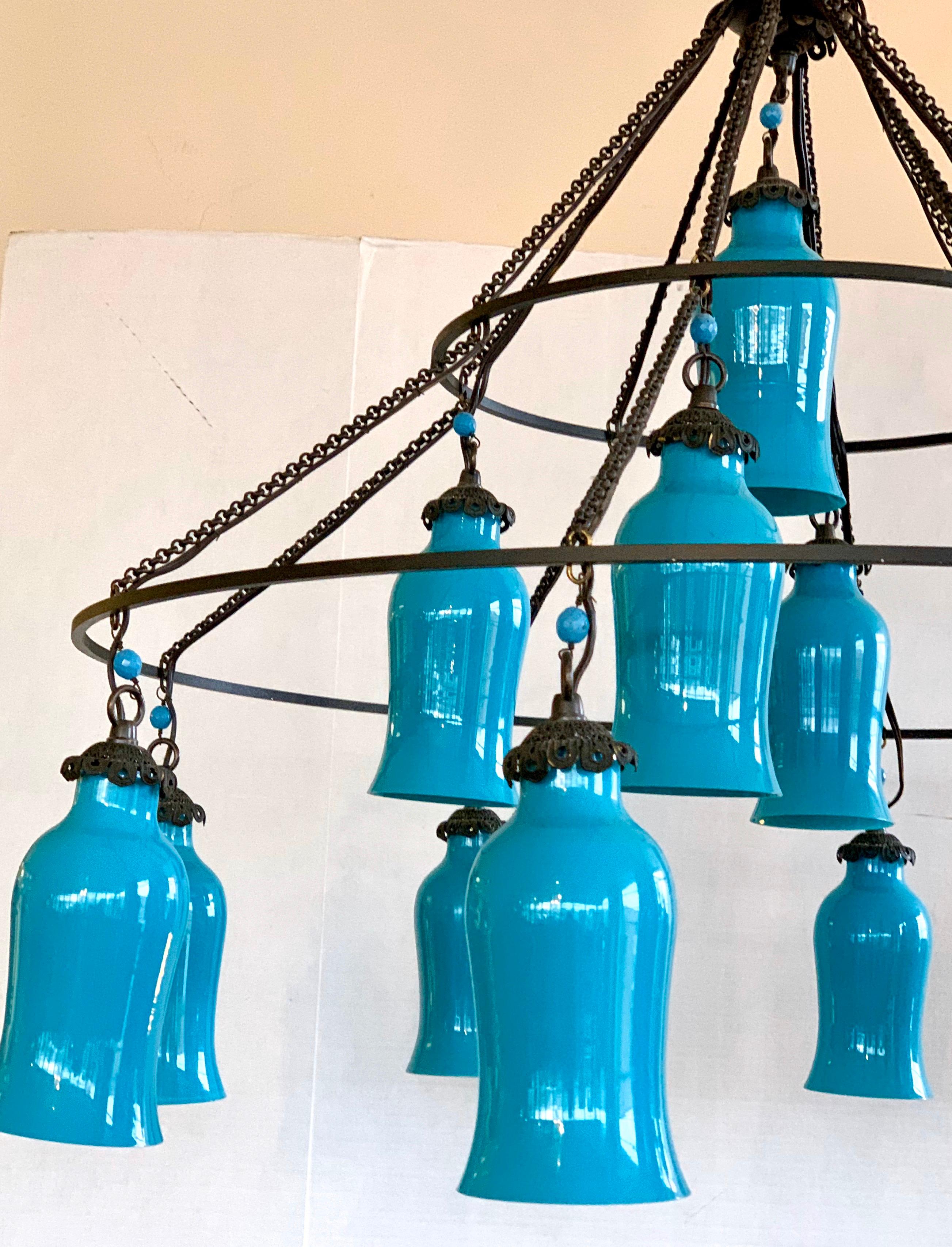 Unusual twelve light chandelier with black wrought iron like frame and turquoise milk glass shades by Liza Sherman, NY.  This amazing piece is not only massive in size but it's visual scale and presents is amazing. Custom-made using Egyptian hand