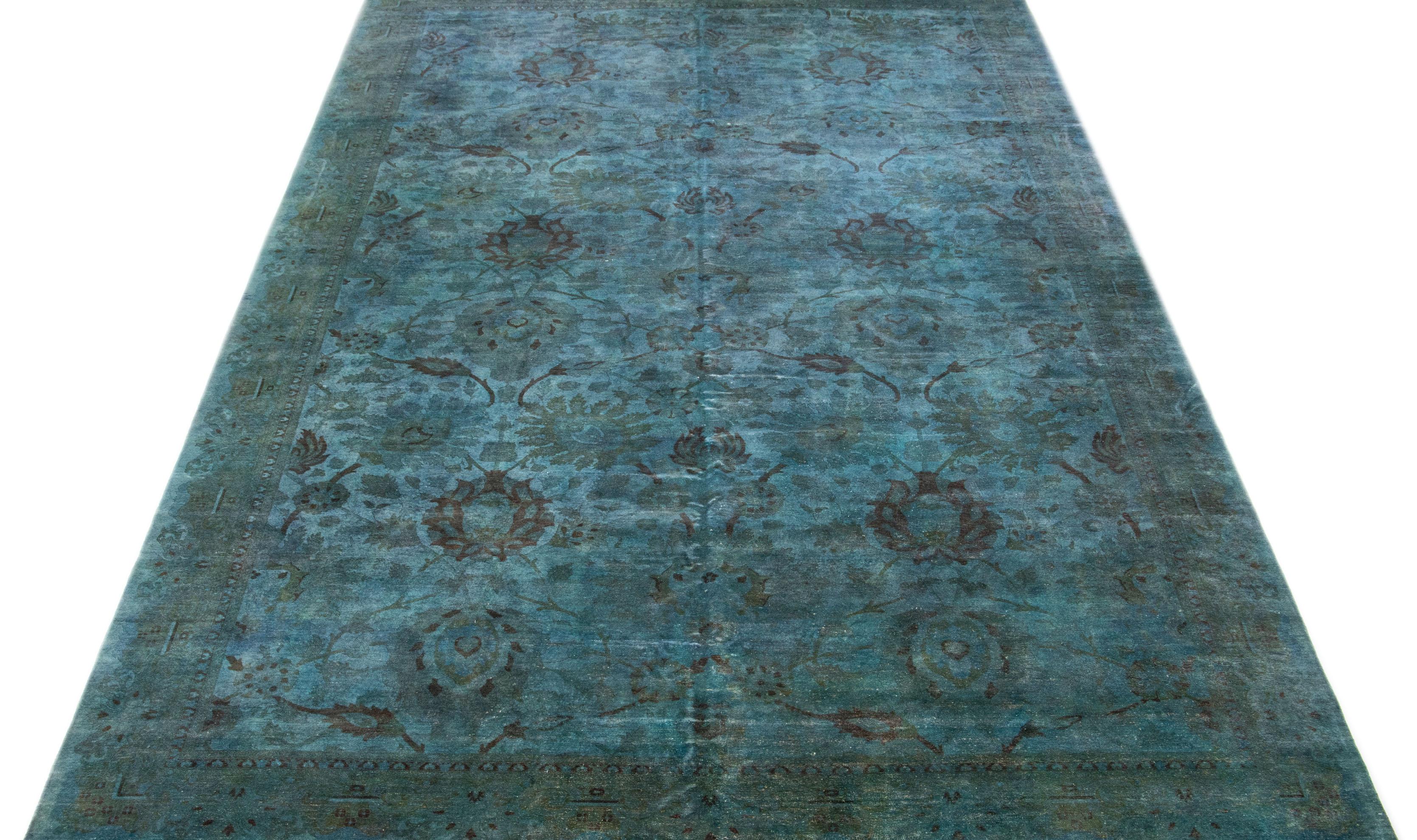 This impressive handmade wool rug features a contemporary art & crafts style with a stunning floral design carefully knotted onto a rich turquoise field. The design is enhanced with various hues of brown that beautifully complement the floral