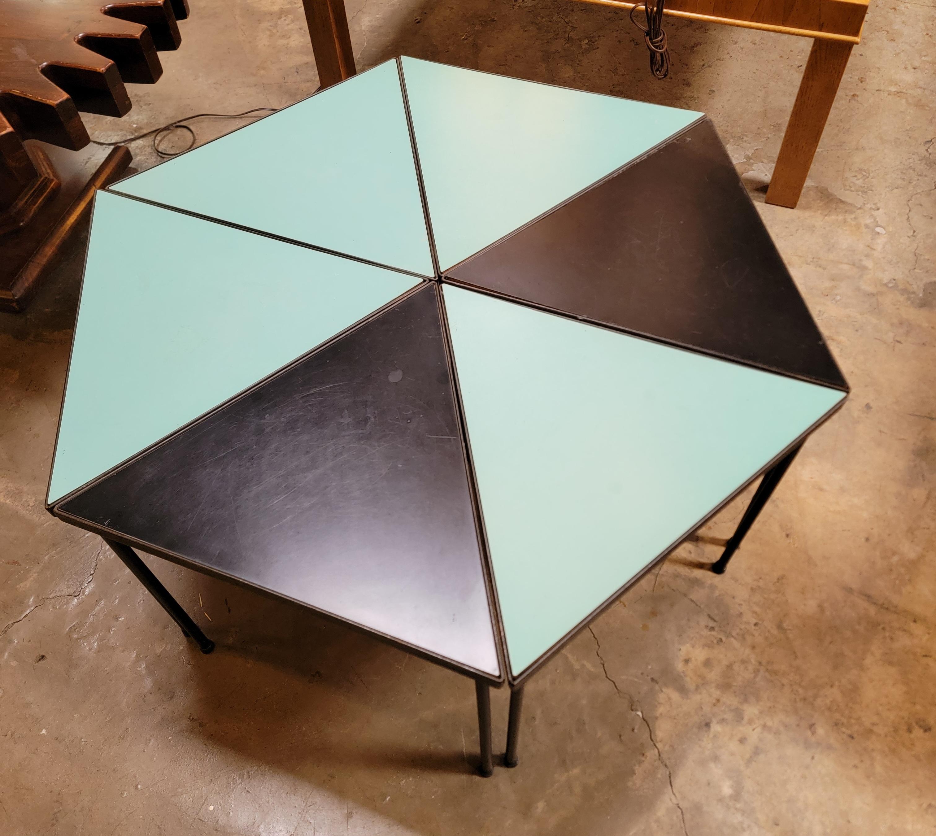 A set of 6 turquoise and black Formica top tables with iron bases. Four turquoise top and two black tops. These tables can be stacked as nesting tables or arranged in multiple configurations to create a coffee table, end or side tables or both.