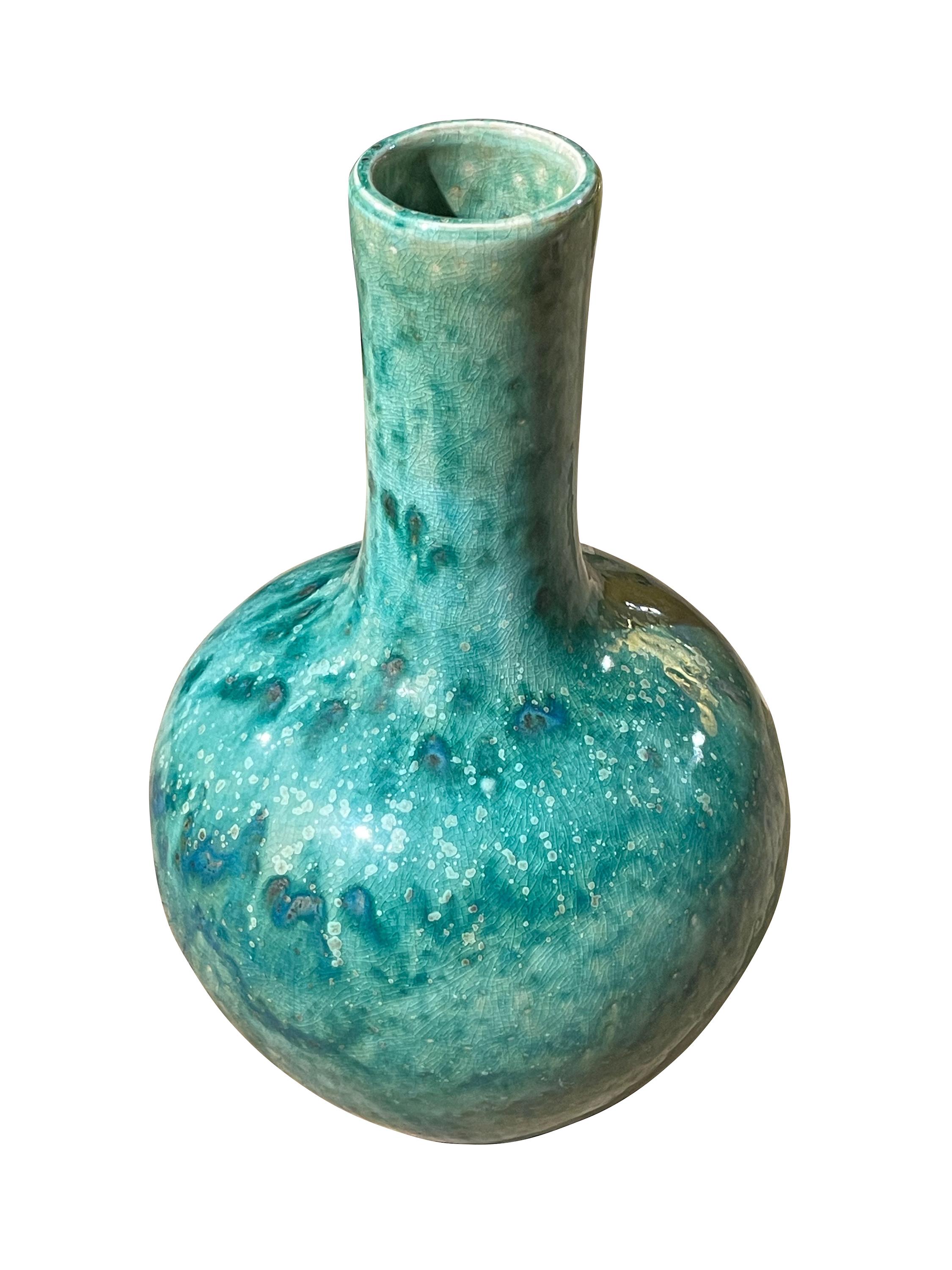 Contemporary Chinese mottled turquoise coloring with crackle glaze vase.
Funnel neck design.
From a large collection of different sizes and shapes.

