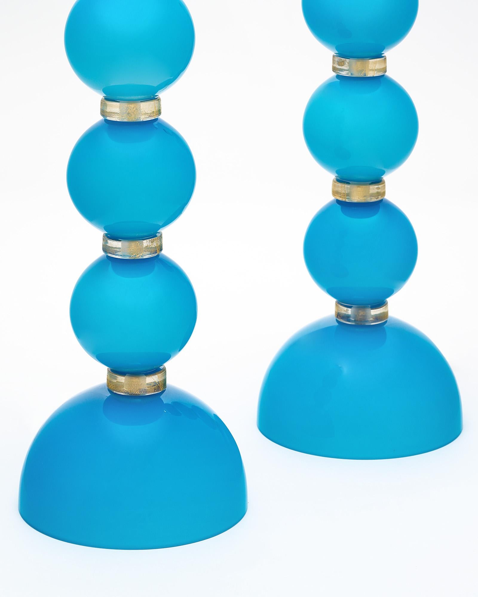 Murano glass table lamps from the island of Murano outside of Venice, Italy. This hand-blown pair has a striking bright turquoise color to the glass elements. They have been newly wired to fit US standards.