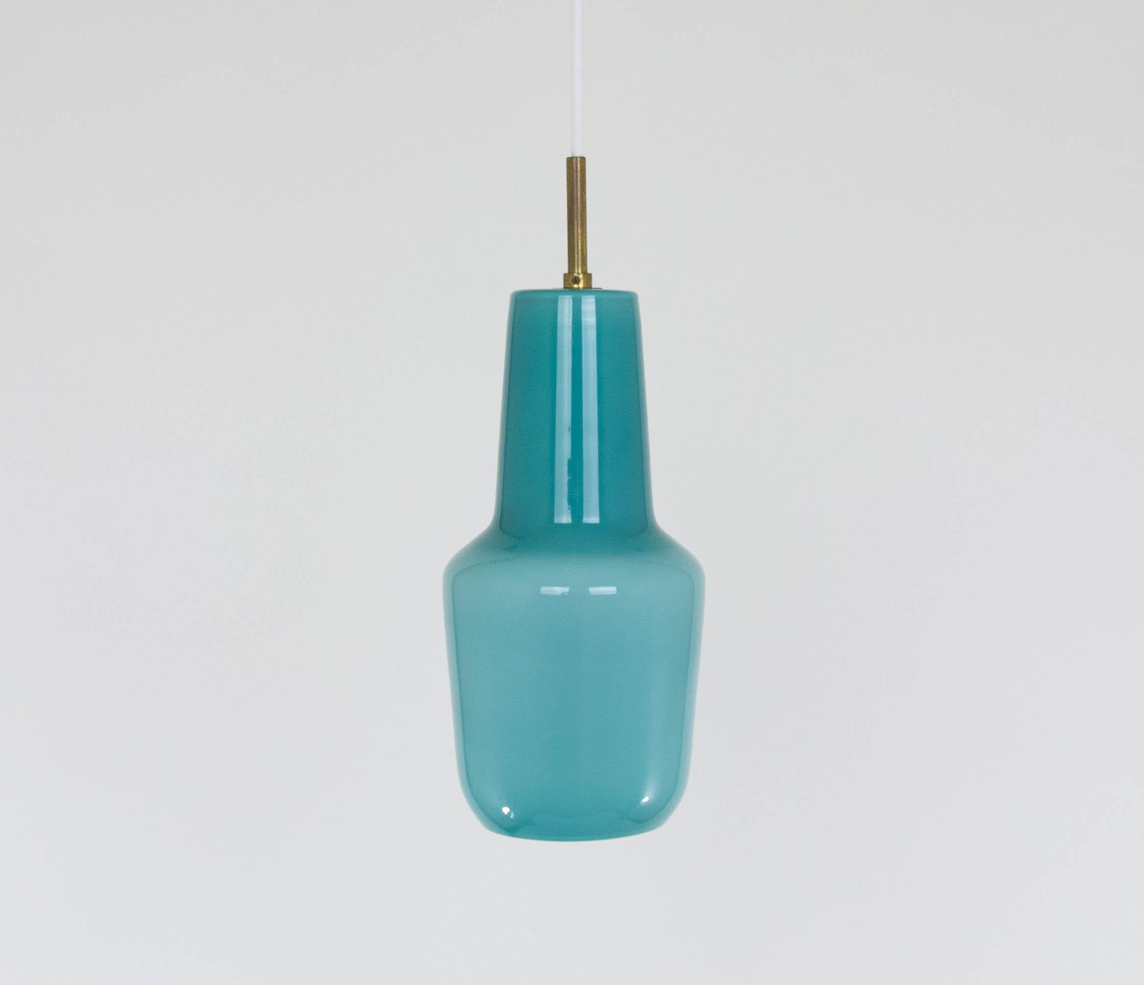 Hand blown turquoise glass pendant designed by Massimo Vignelli at the start of his impressive career in design and produced by Murano glass specialist Venini.

This model was made in three sizes: 25 cm, 30 cm and 39 cm high. This one is the