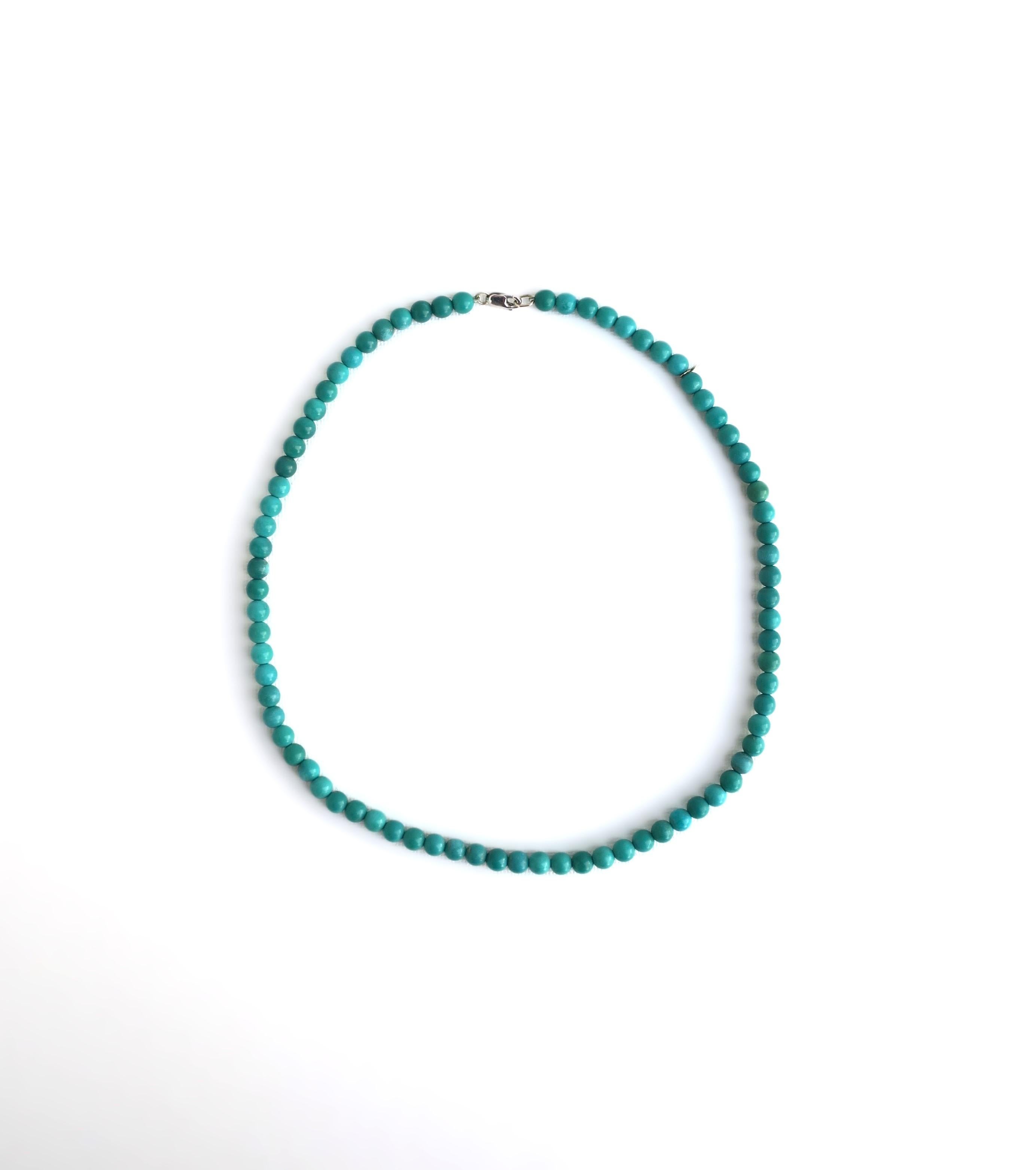 A beautiful and chic blue turquoise stone bead necklace and choker necklace in one. Two necklace lengths in one. Necklace is shown worn in both lengths. Necklace is beautiful as a standalone piece but also makes a great stacking necklace looking