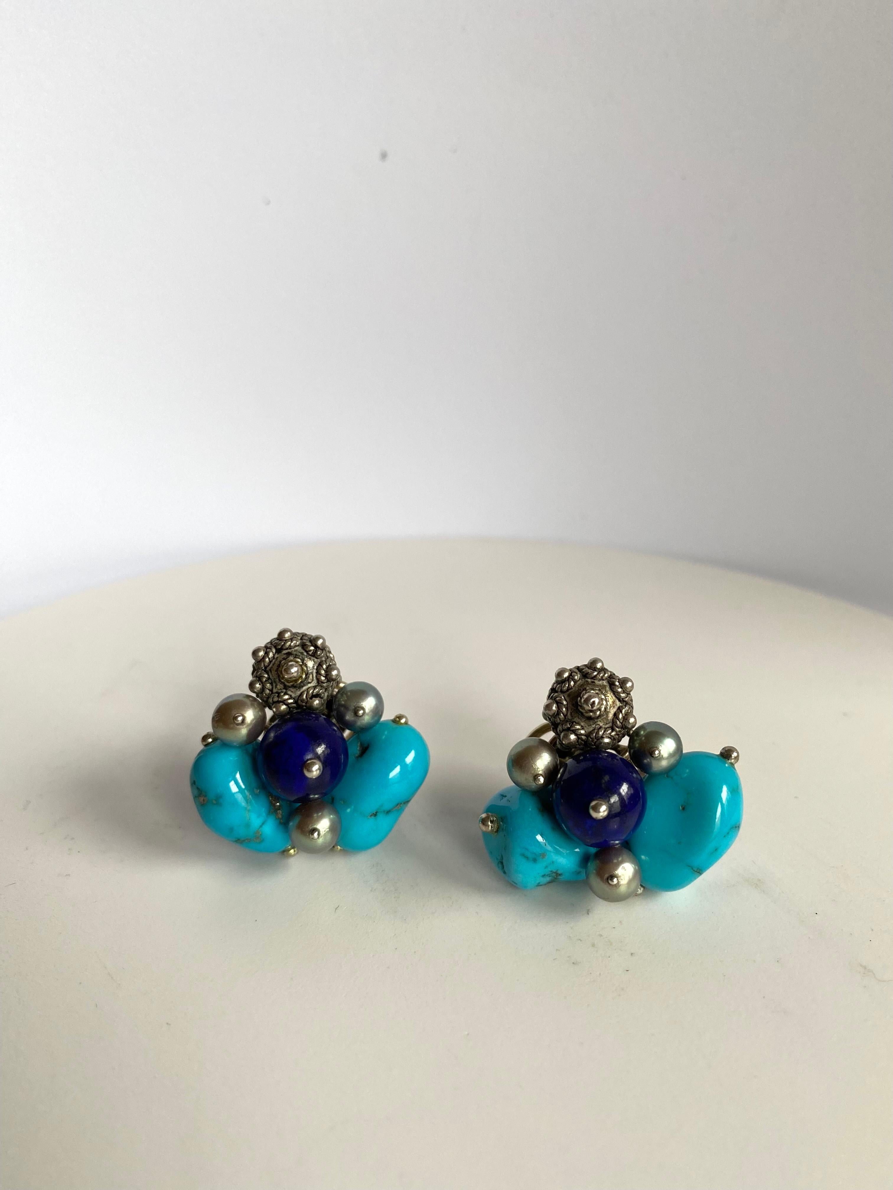 A cluster Earrings of natural Turquoise nuggets with granulated antique silver bead, lapis bead center and accents of gray pearls. Set in 18 karat white gold, signed Sorab & Roshi.

1