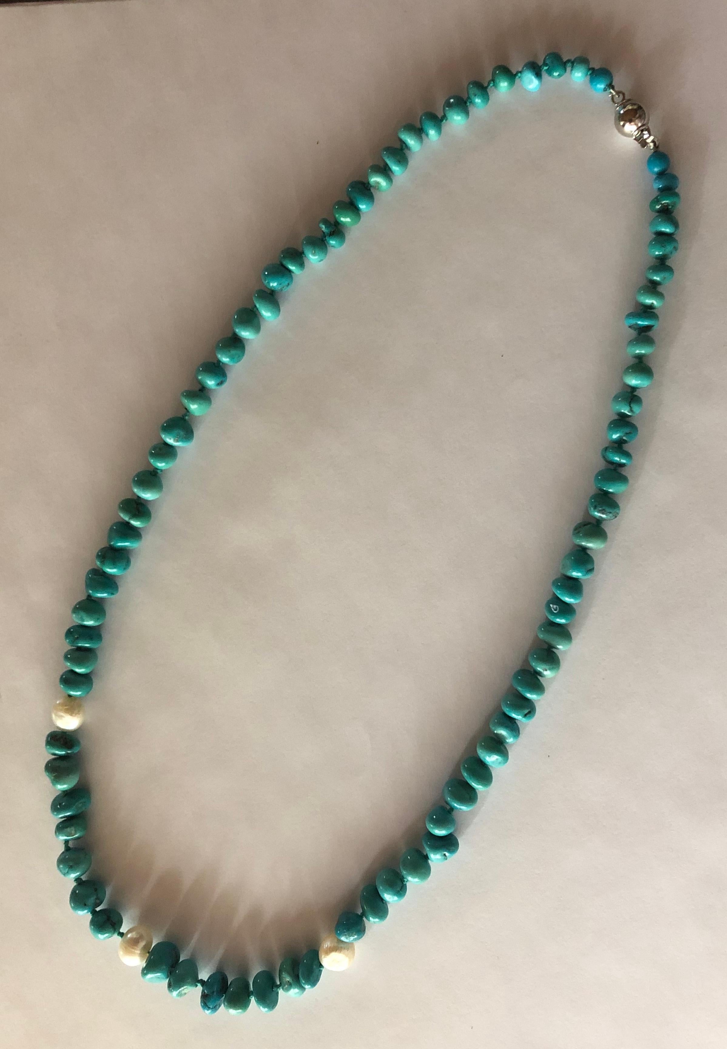 Turquoise nuggets necklace with sweet water pearls and 18Kt white gold clasp. 80 turquoise nuggets of different dimensions, and matching turquoise color. 3 Pearls. Made in Italy. 750 stamp.

Please do hot hesitate to ask for further information or