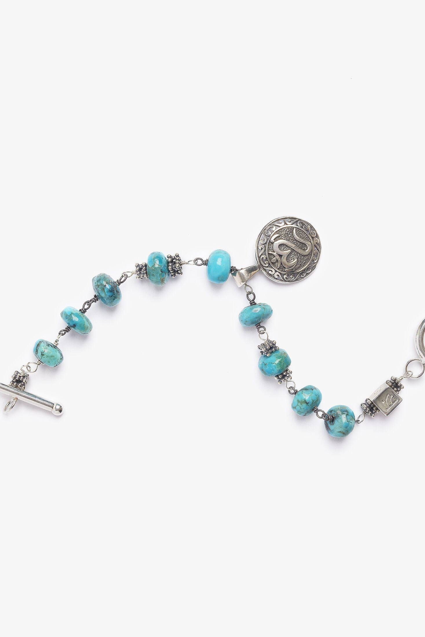 This piece is inspired by the beautiful beaches in Canguu, Bali and comprised of vibrant copper turquoise.  The bracelet is peppered with symbolism.  Pantai means beach in Indonesian.  The bracelet is adorned with a unique pendant is the Balinese OM