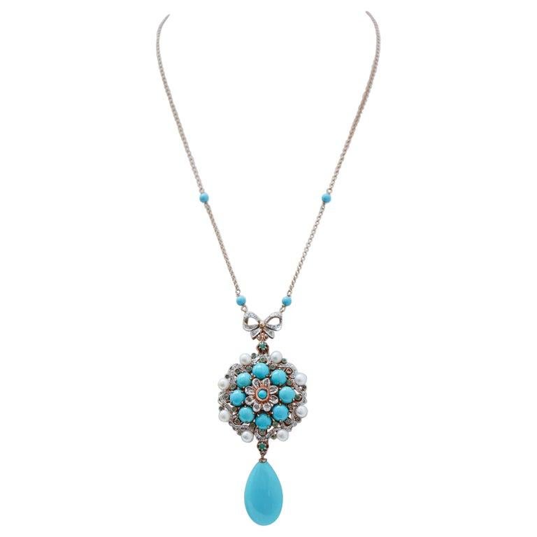 Fantastic pendant necklace in 9 kt rose gold and silver structure mounted with four turquoise along the chain. In the upper part of the pendant, a bow mounted with diamonds. The pendant is mounted with a central flower of diamonds and a central