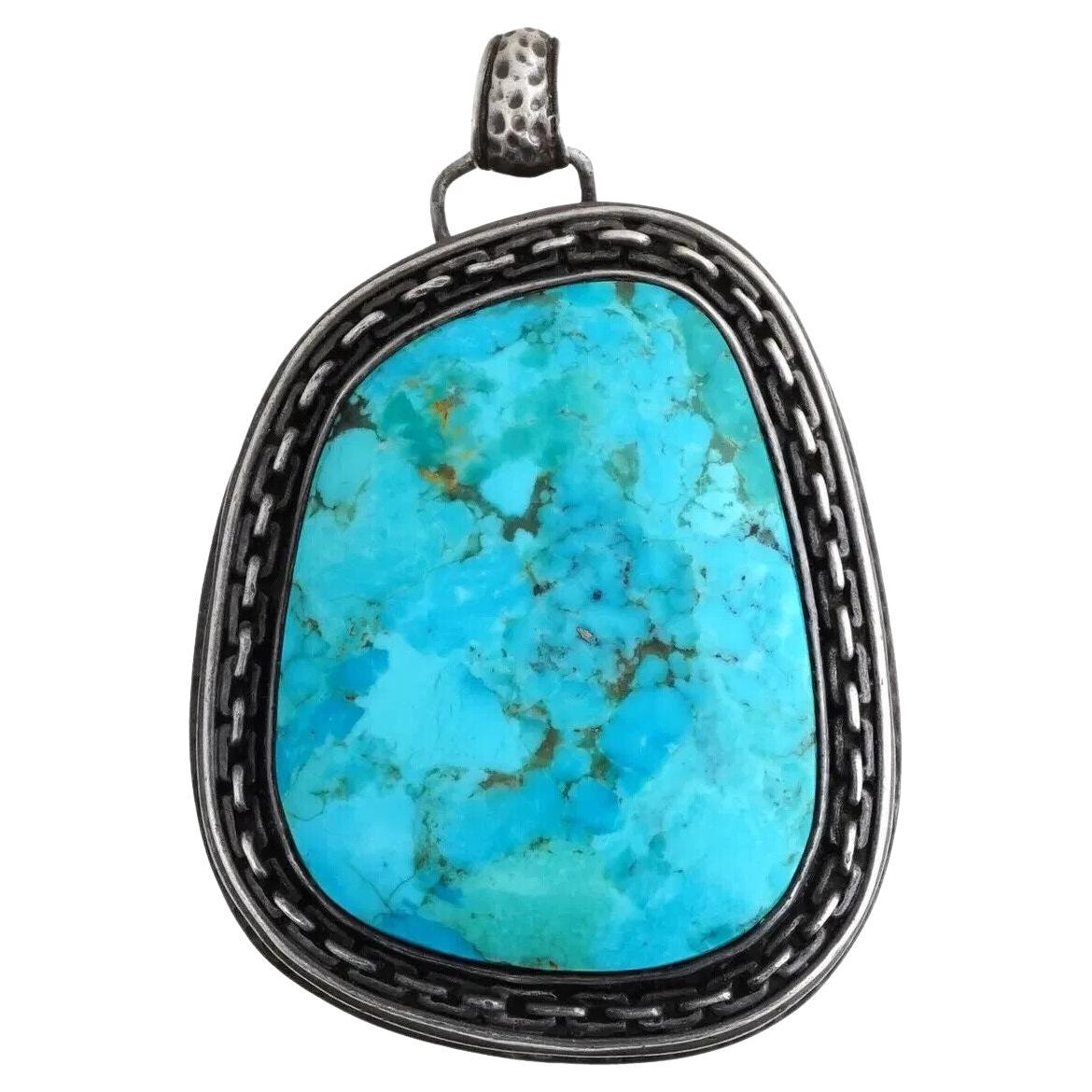 Ciondolo turchese con cornice decorativa in argento