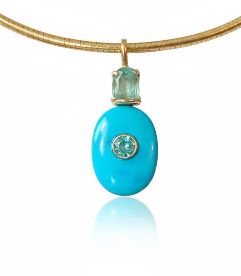 Turquoise Pendant

Turquoise, Emeralds, Diamond 
14k Gold

This stunning, one-of-a-kind  pendant is 1.25” in length and a bit over 1” in width. The beautiful, natural turquoise has a center 4mm round emerald bezeled in 14k gold and a top 8x6mm