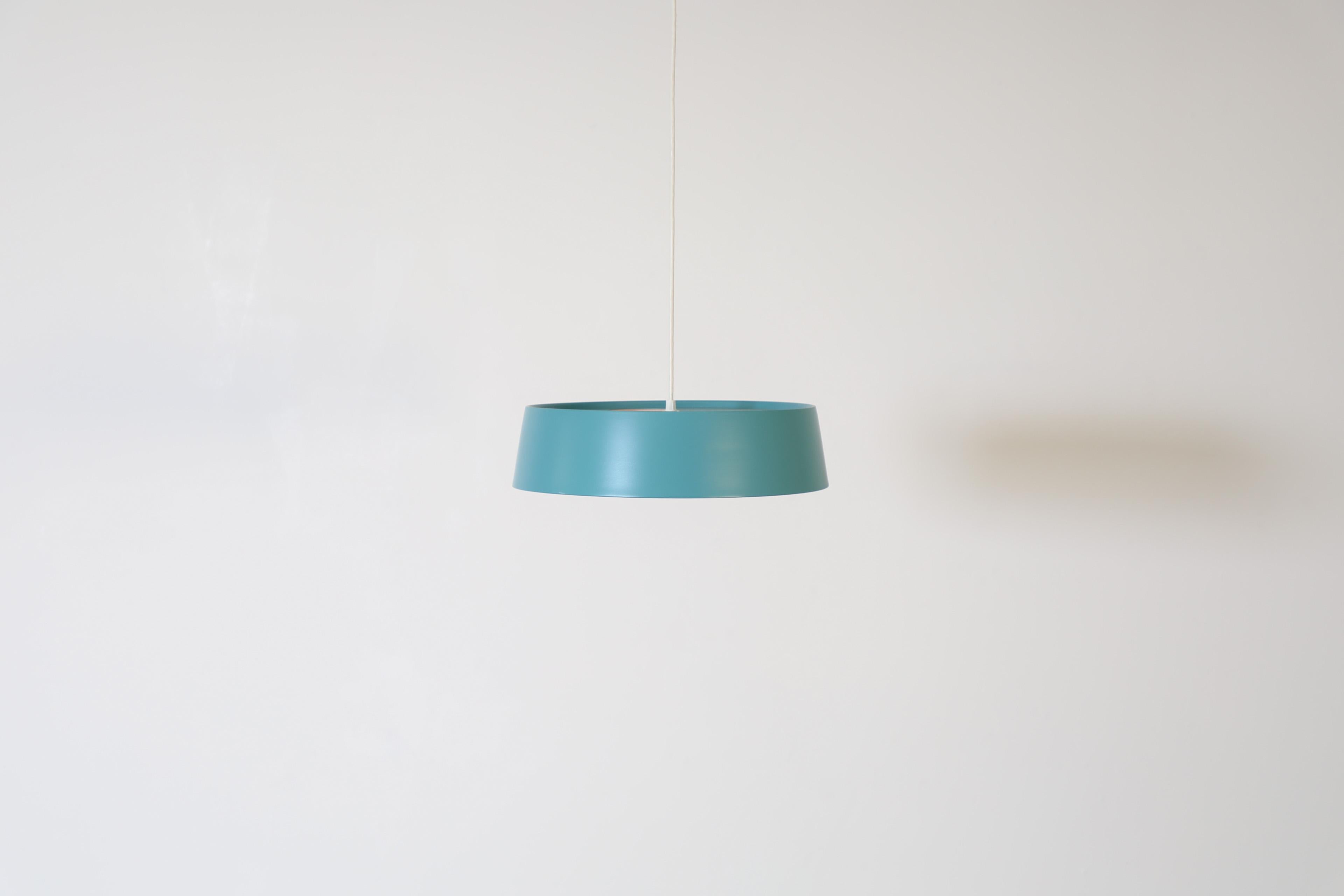 Beautiful, Dutch Mid-Century, Philips designer Louis Kalff attributed ceiling pendant with a (newly painted)Turquoise shade and highly decorative, circular cut-out details. A bright and chic ceiling light in otherwise original condition with some